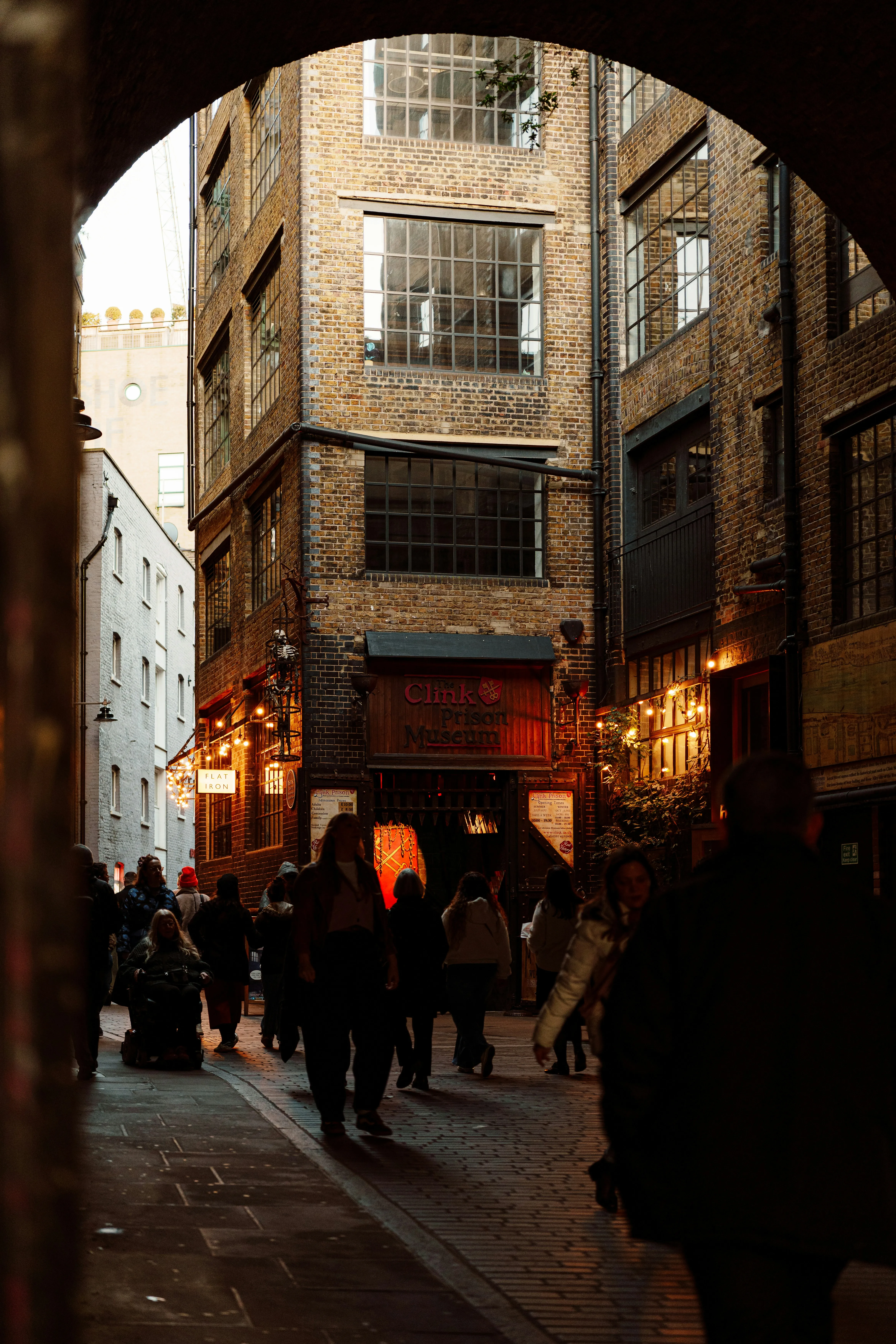 Enchanting Dusk: Pedestrians in a Historic Brick Alleyway