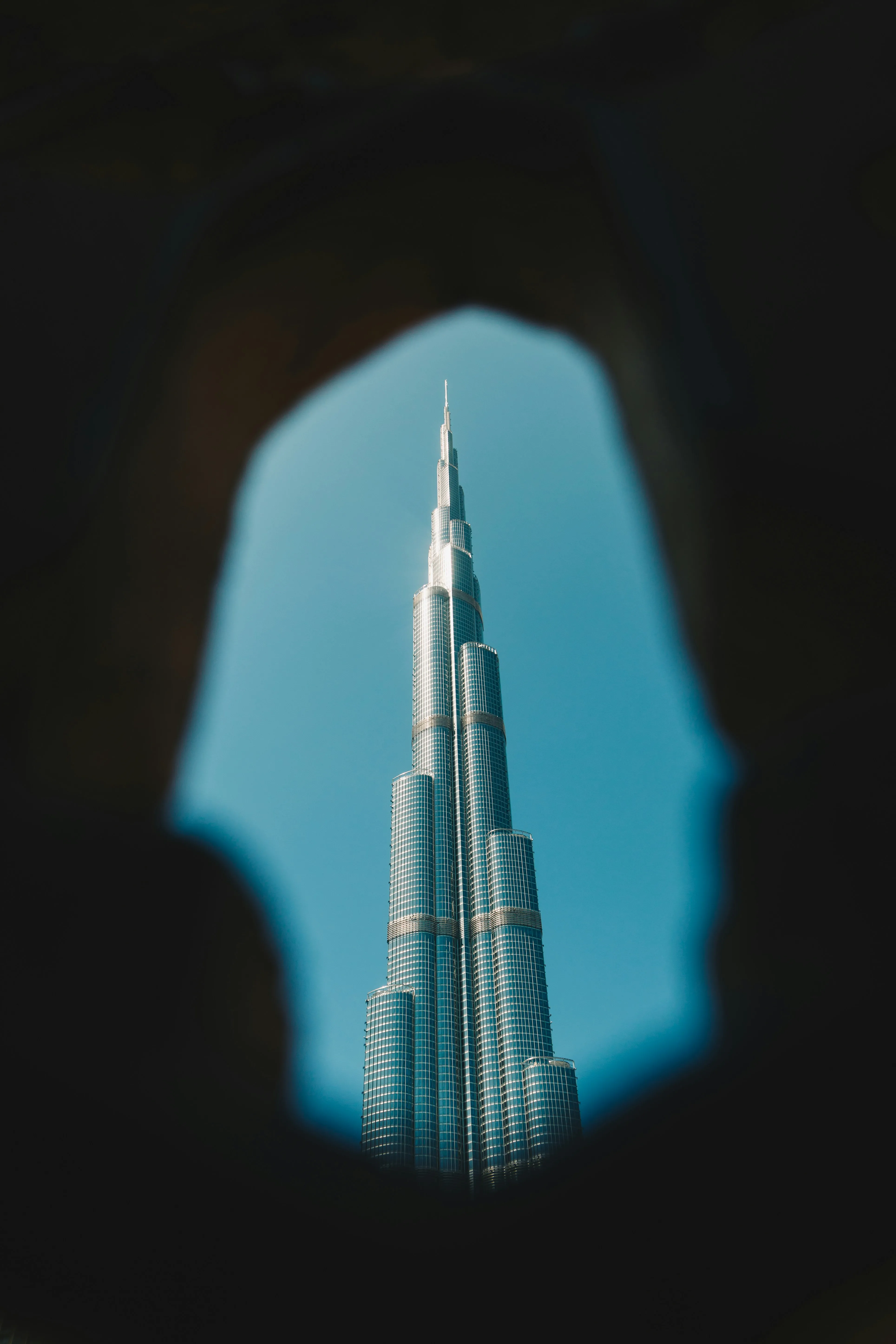 Dramatic Glimpse: Burj Khalifa Soaring Through a Dark Archway