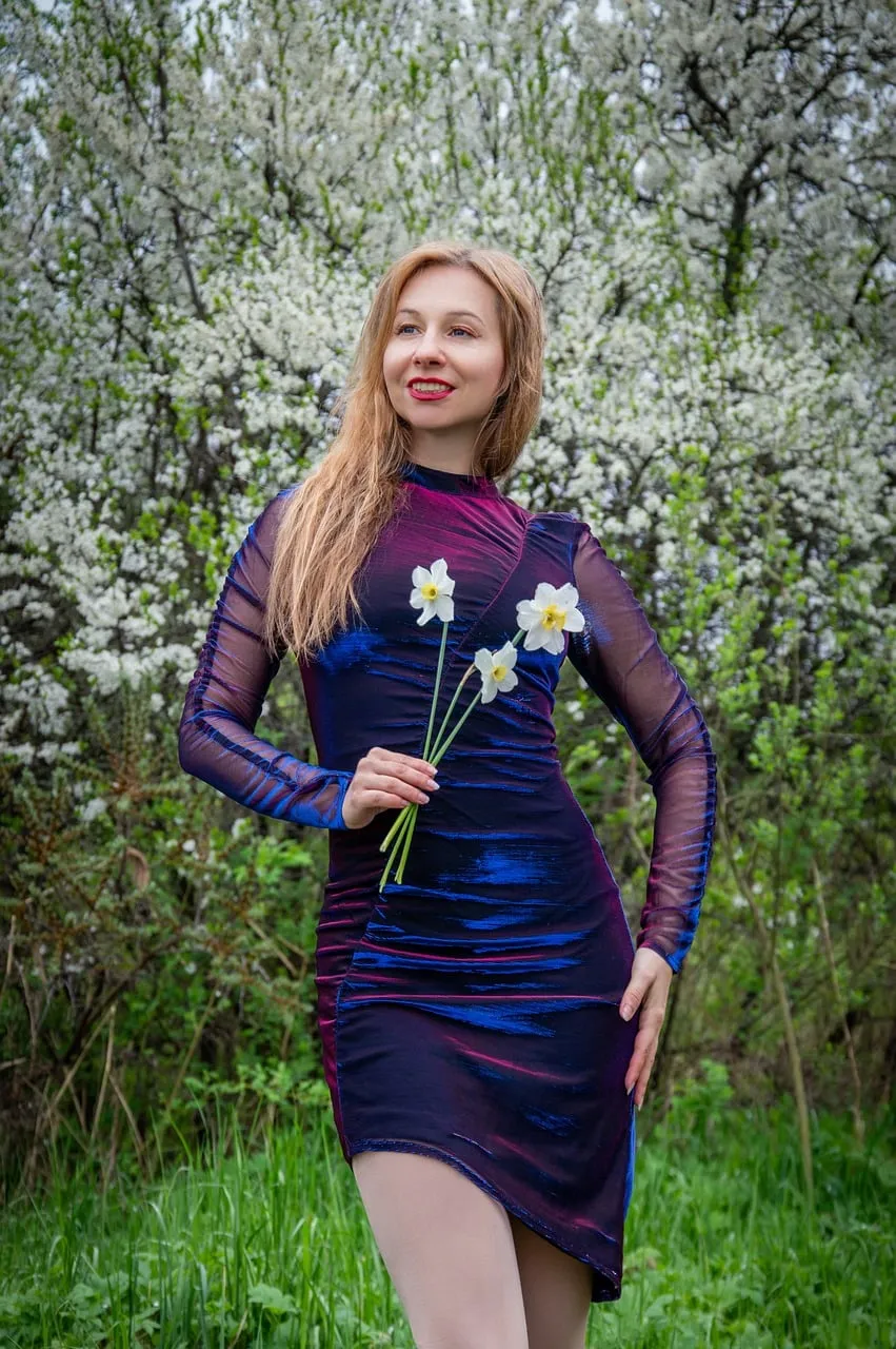 Stunning Spring Fashion: Woman Posing Amidst Blooming White Irises