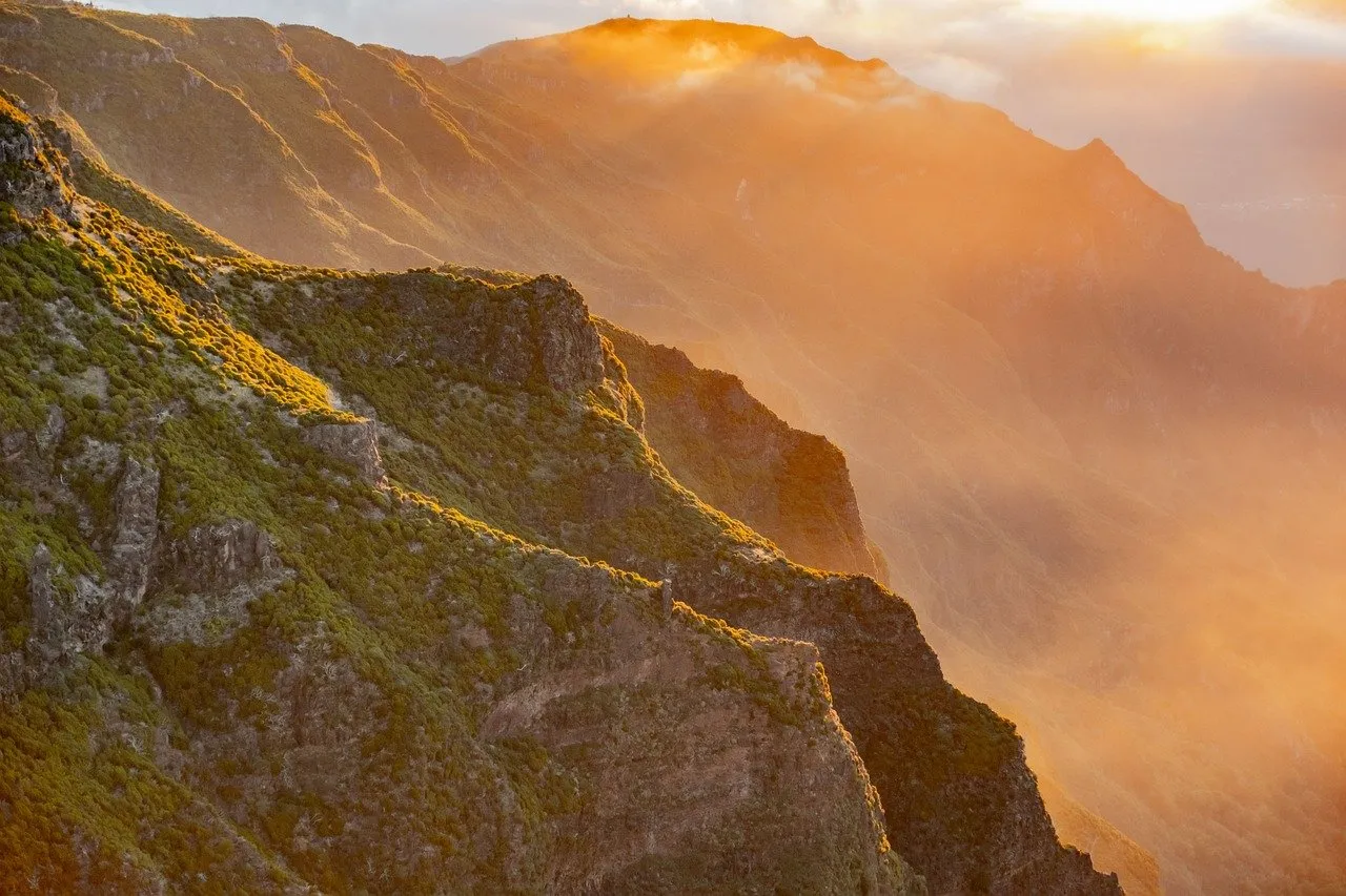 Golden Summit: Breathtaking Sunrise over Madeira Mountains