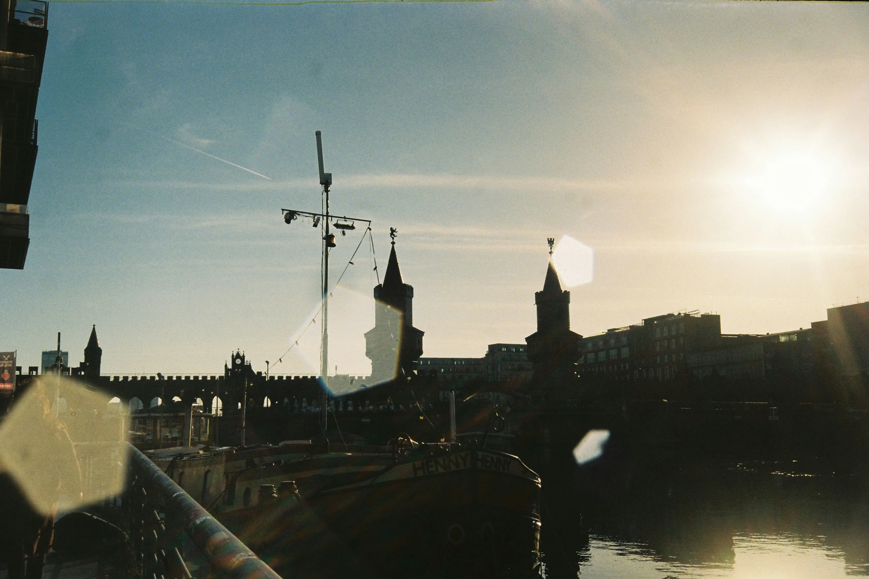 Dramatic Sunset Glow Over City Skyline and Historic Bridge