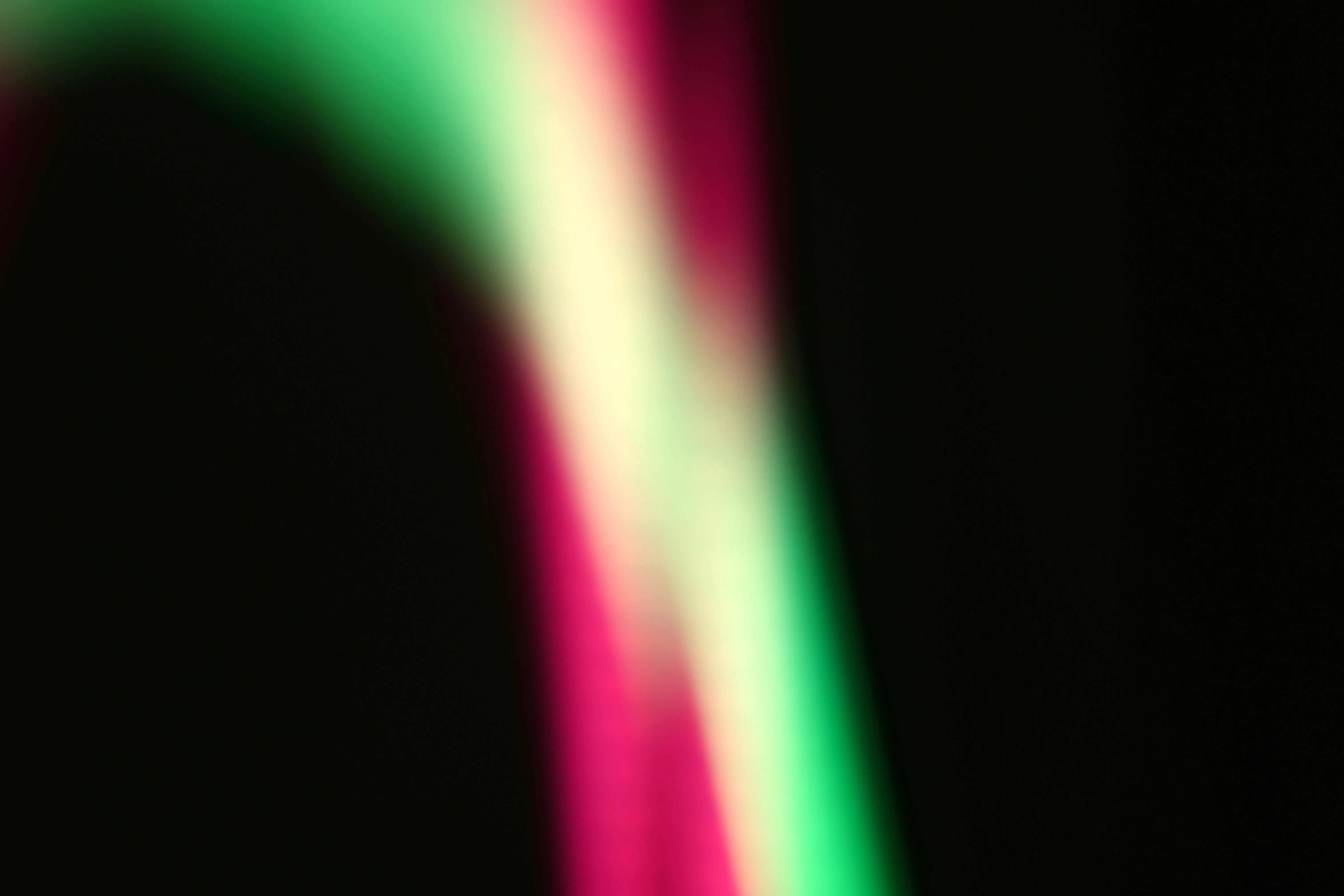 Vibrant Abstract Light Streaks: Pink, Yellow, Green Glow