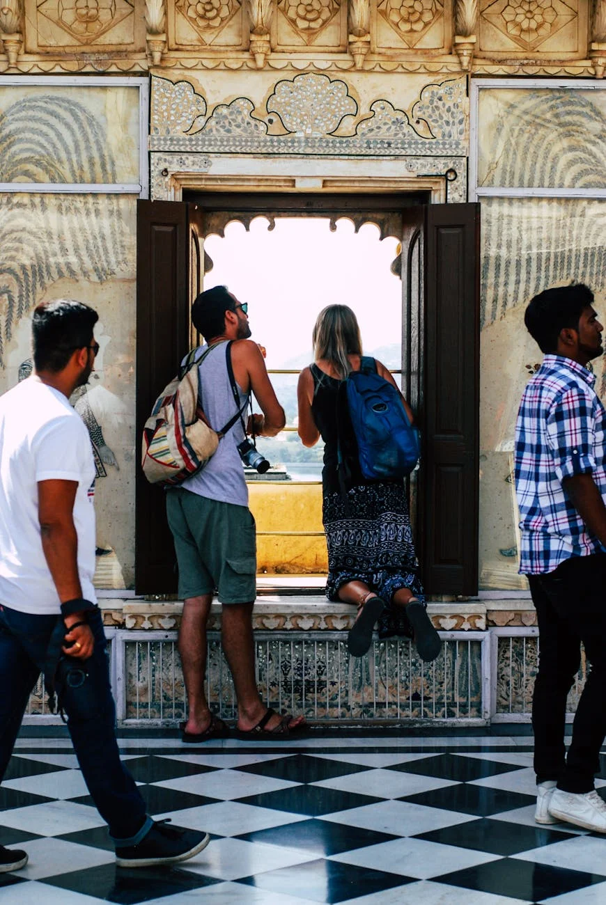 Ancient Palace Views: Tourists Gaze from Ornate Windows