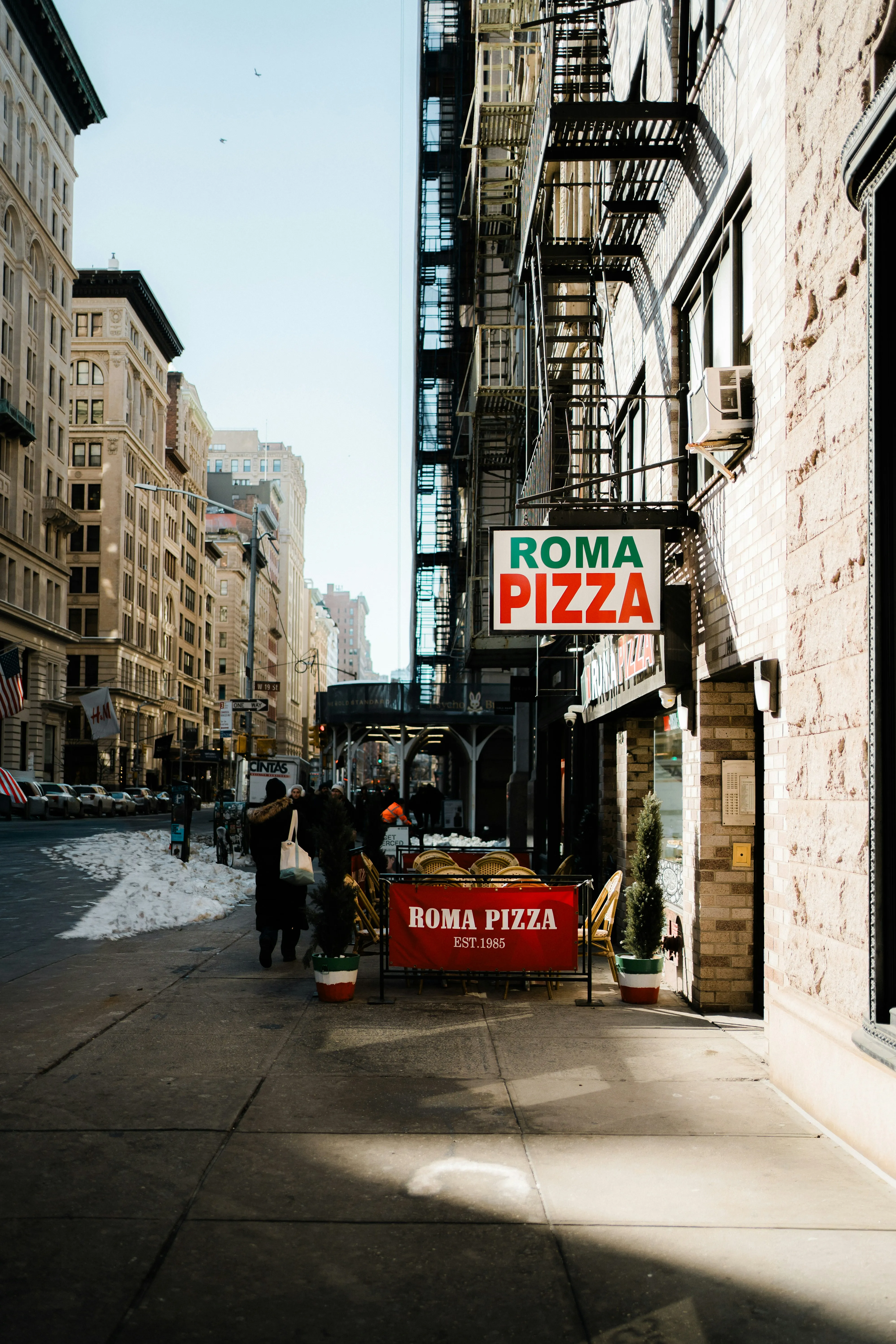 Vibrant Roma Pizza Sign on a Bustling City Street