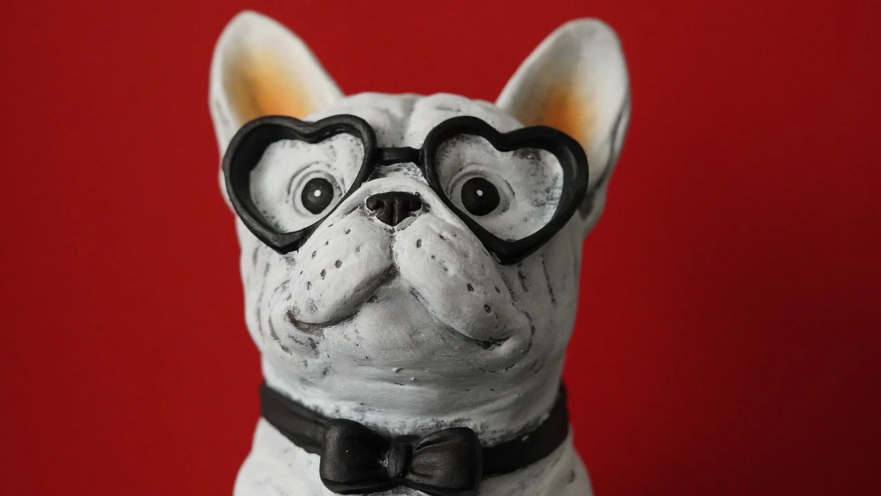 Charming French Bulldog in Heart Glasses against a Vivid Red Background