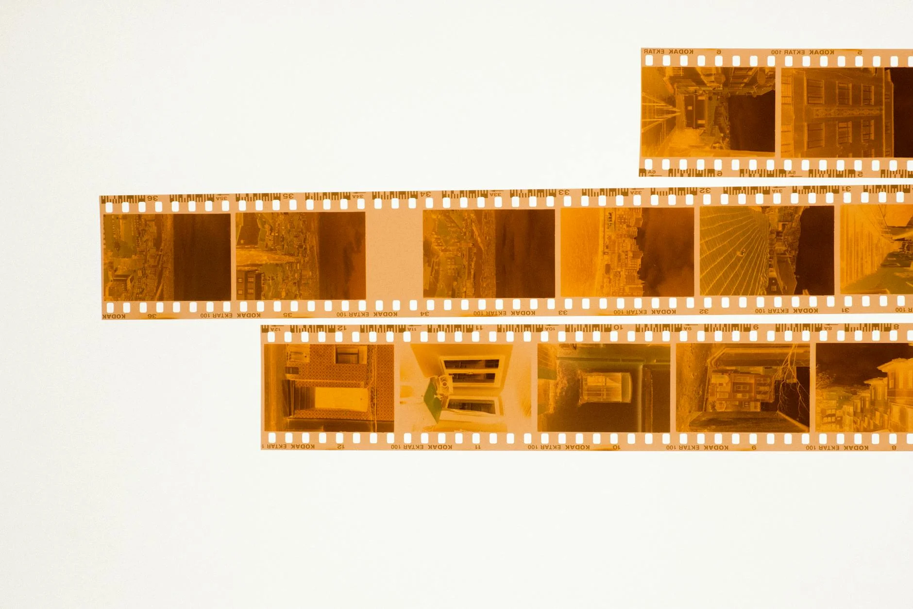 Timeless Memories: Golden Film Strips on White Background