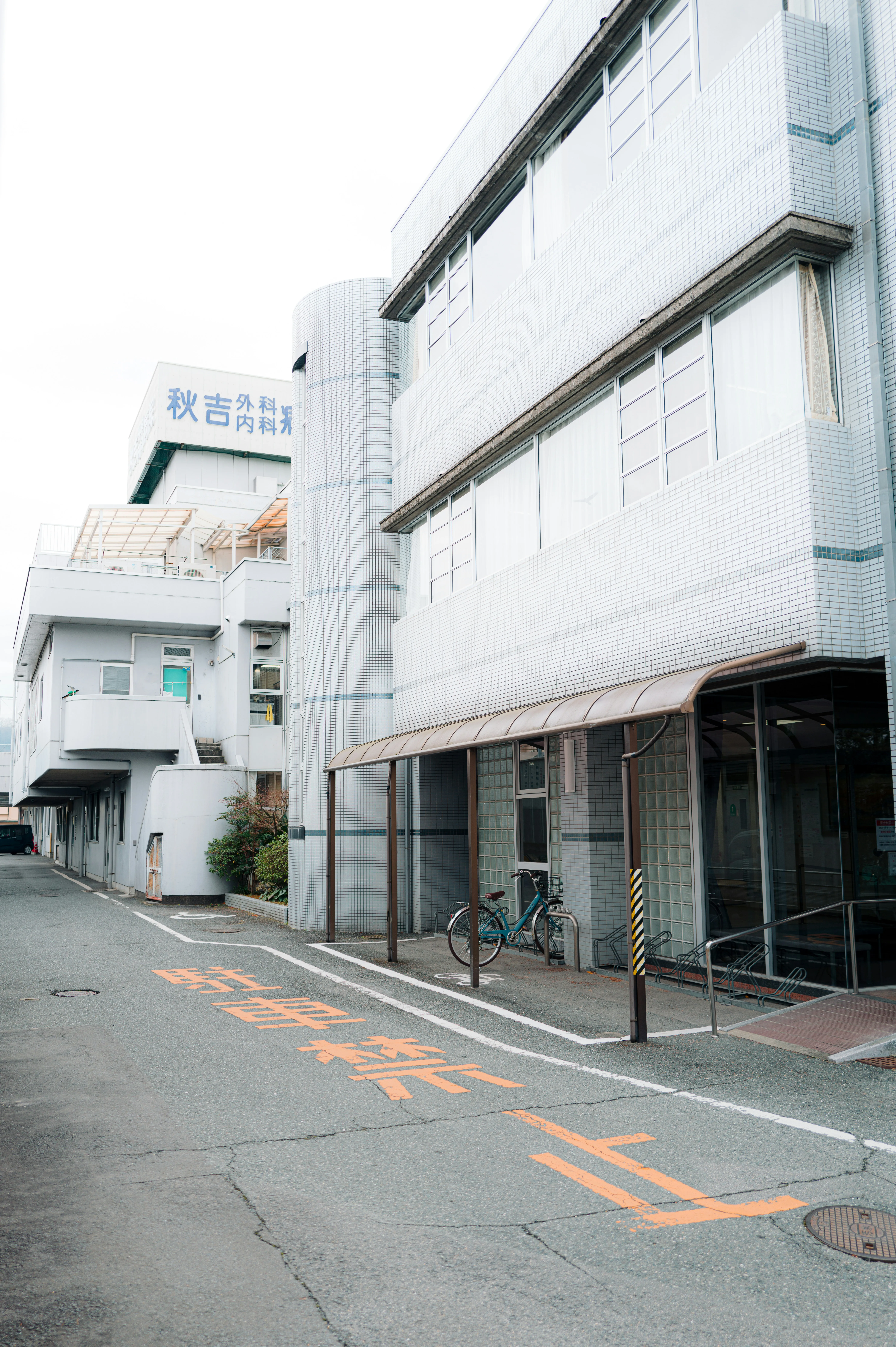 Urban Serenity: Japanese Street with White Architecture and Bicycle
