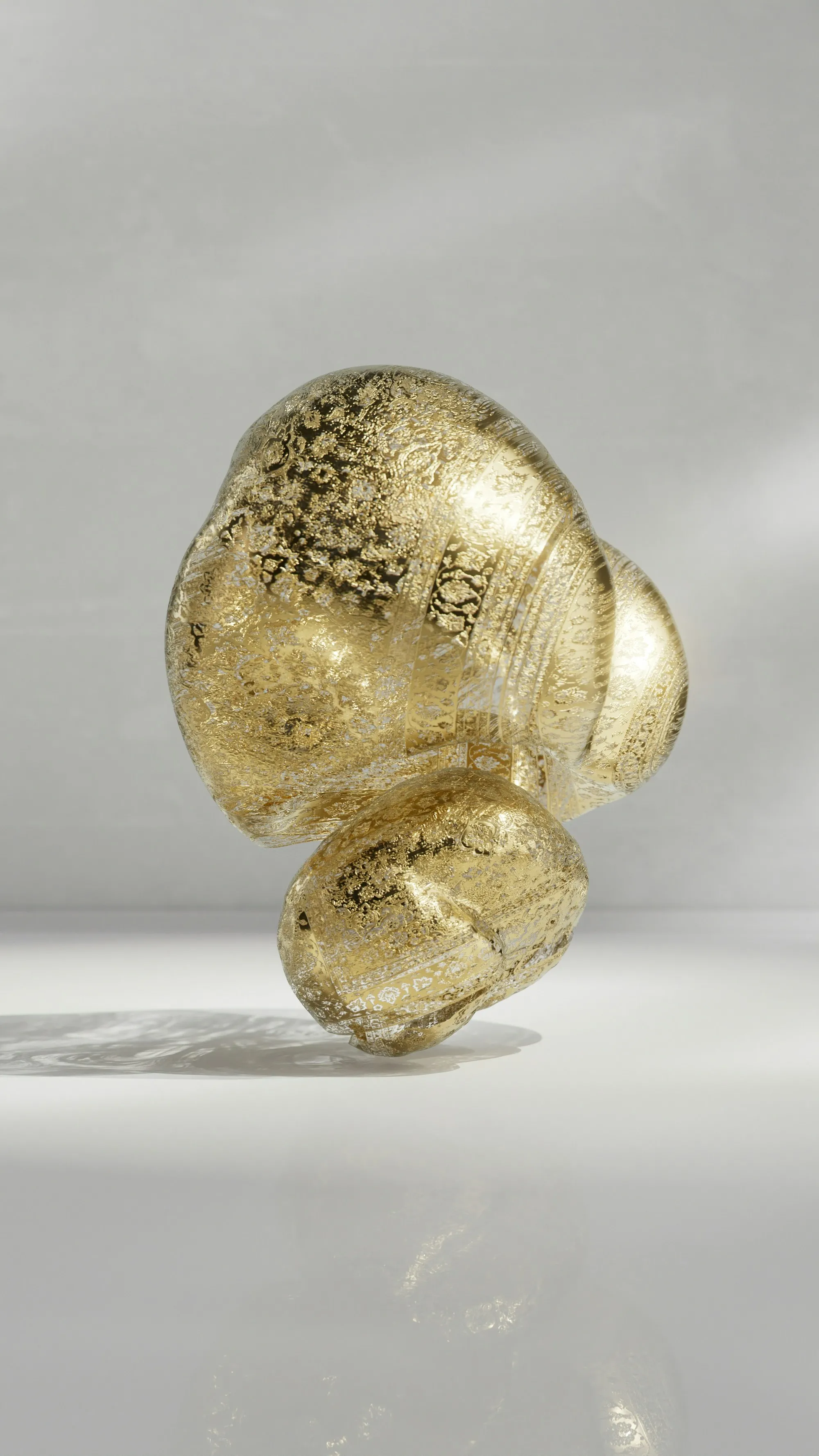 Glistening Gold: Abstract Sculpture on Reflective Surface