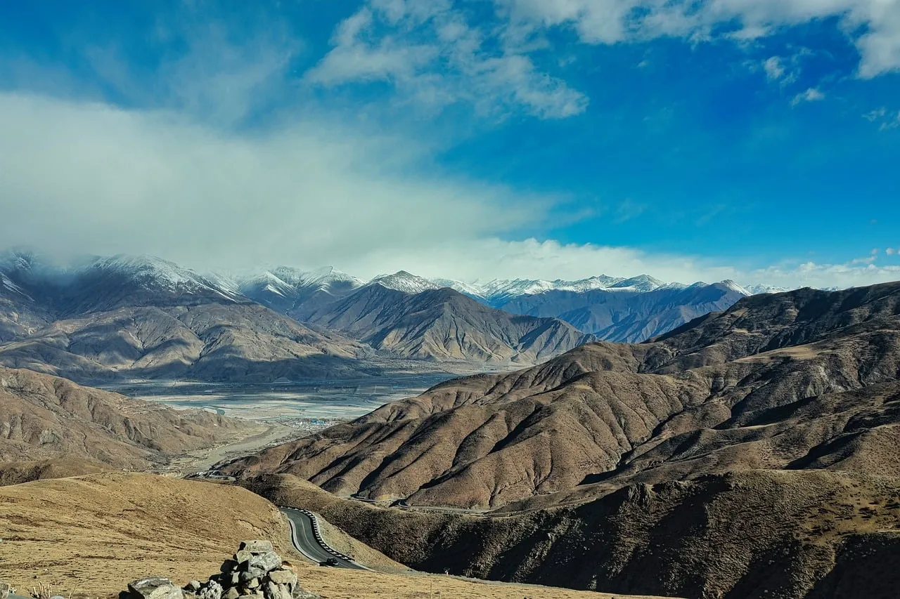 Breathtaking Mountain Panorama: Winding Road Through Majestic Peaks