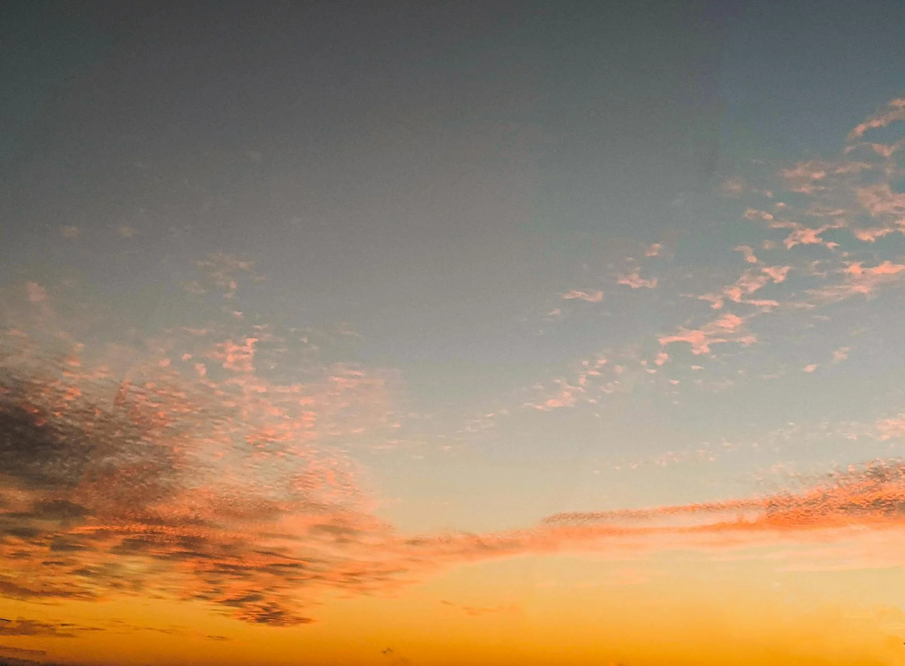 Breathtaking Sunset Sky with Fiery Hues and Serene Clouds