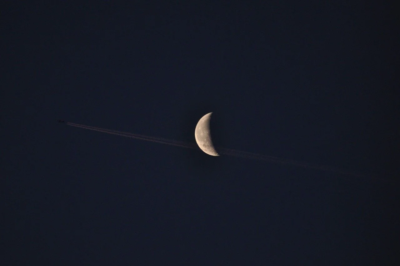 Celestial Duo: Crescent Moon and Trailing Jet
