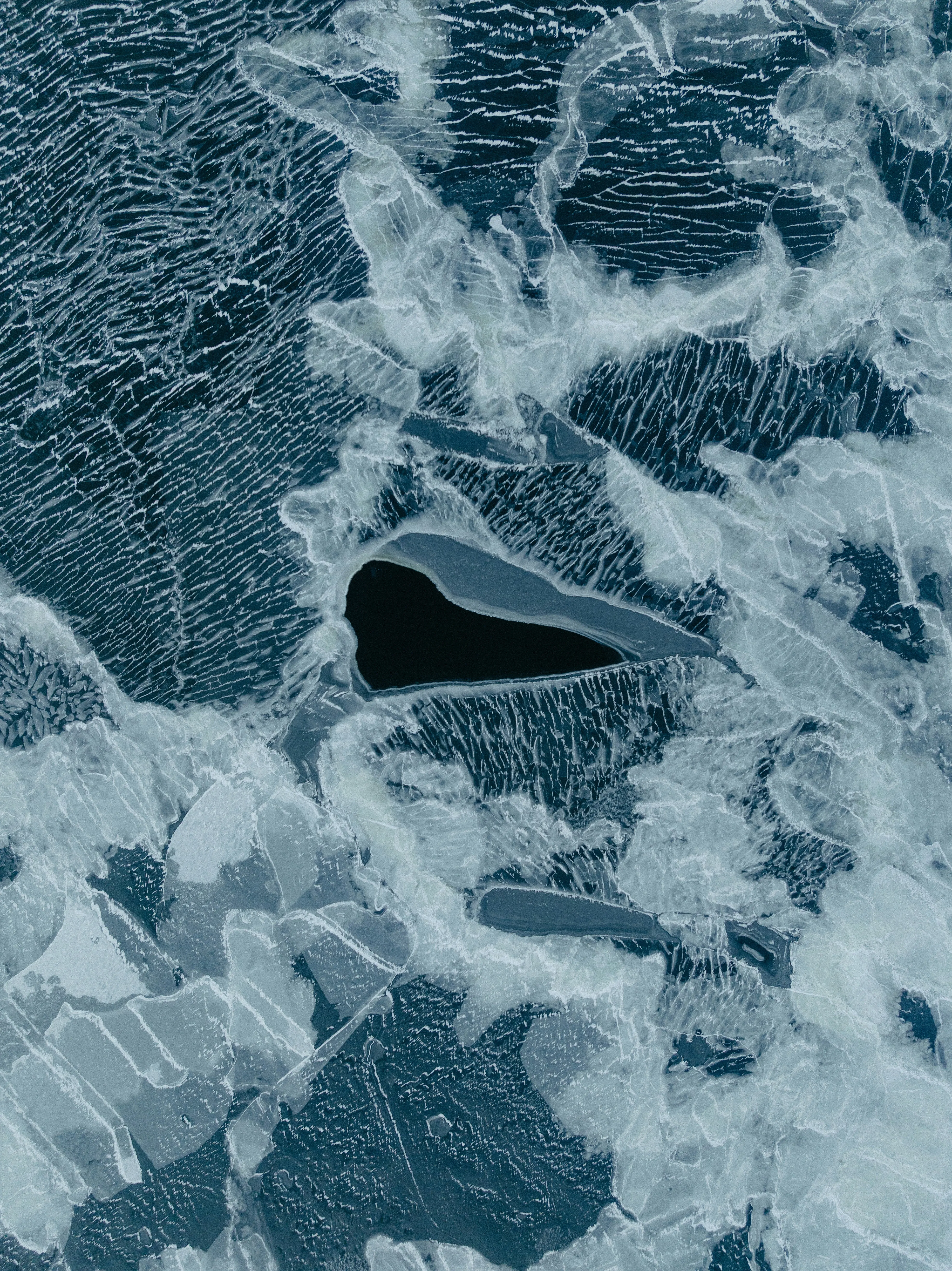 Stunning Abstract Ice Patterns with Dark Water Pockets