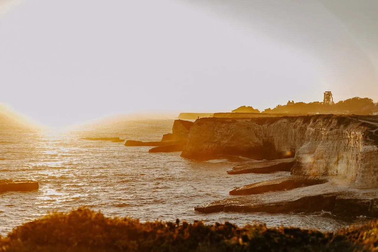 Golden Hour Majesty: Sunset over Dramatic Coastal Cliffs