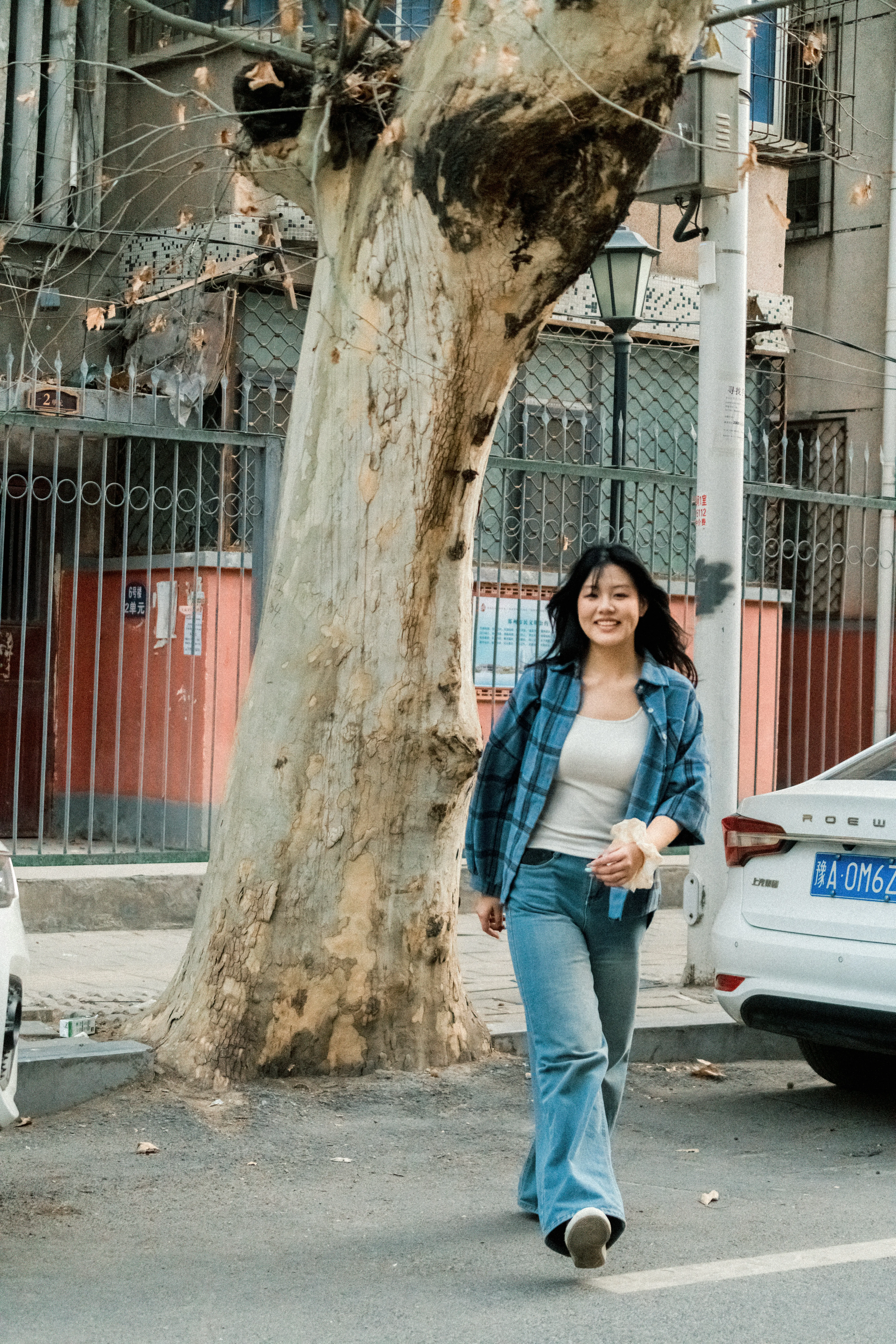 Vibrant City Stroll: Young Woman's Joyful Urban Walk
