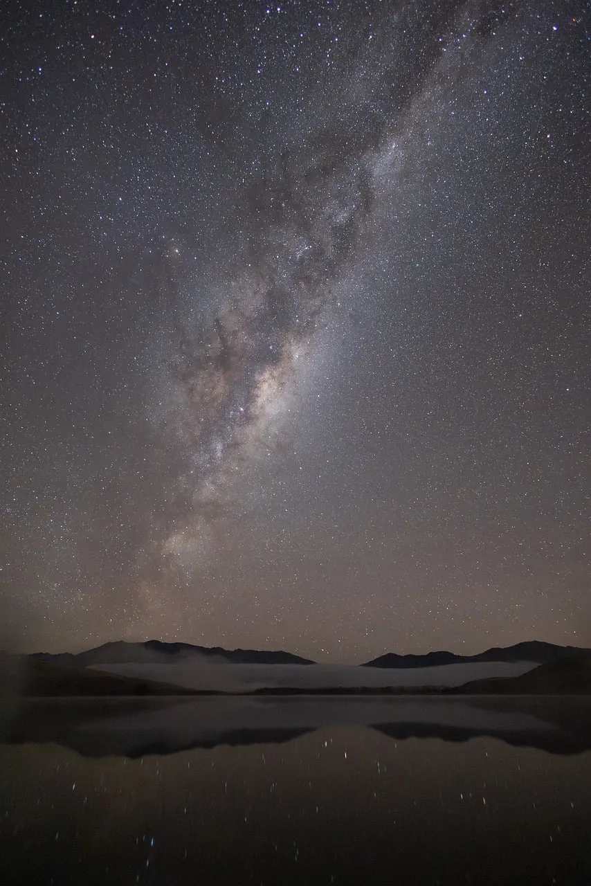 Breathtaking Milky Way Reflecting Over Serene Mountain Lake