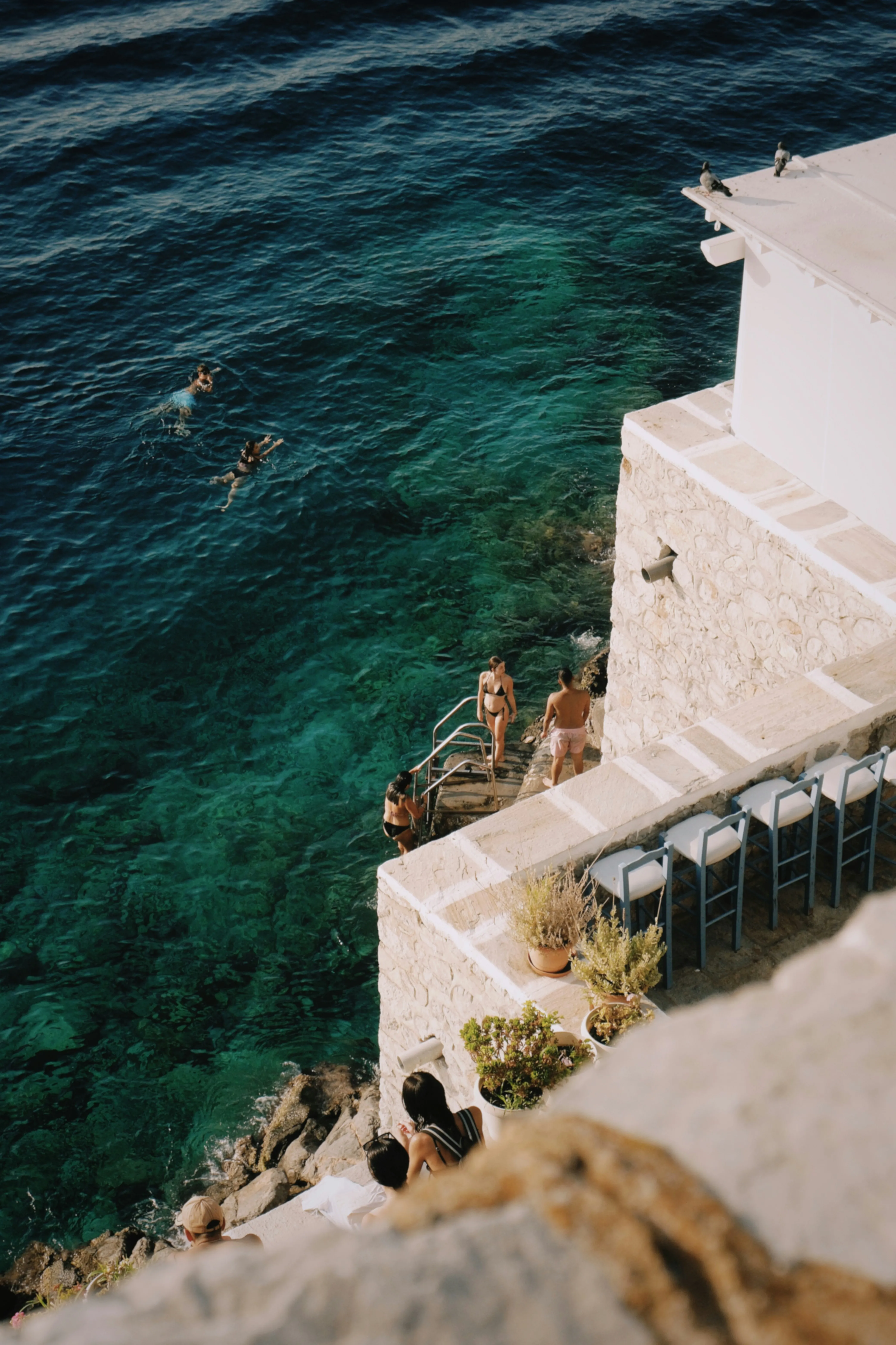 Stunning Aegean Waters: People Enjoying a Refreshing Swim