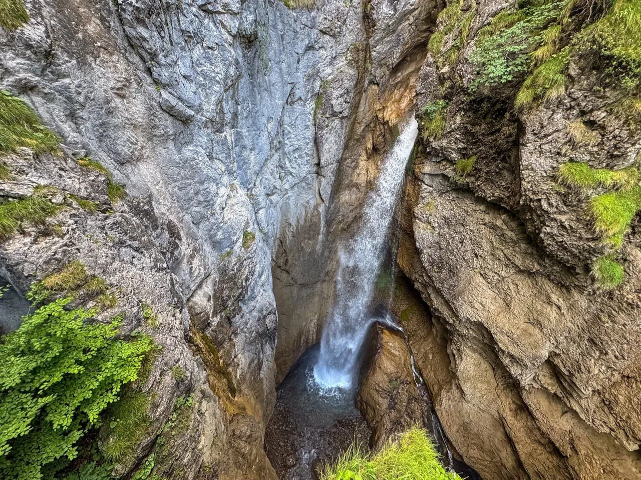 Majestic Alpine Waterfall Plunging Through Ancient Limestone