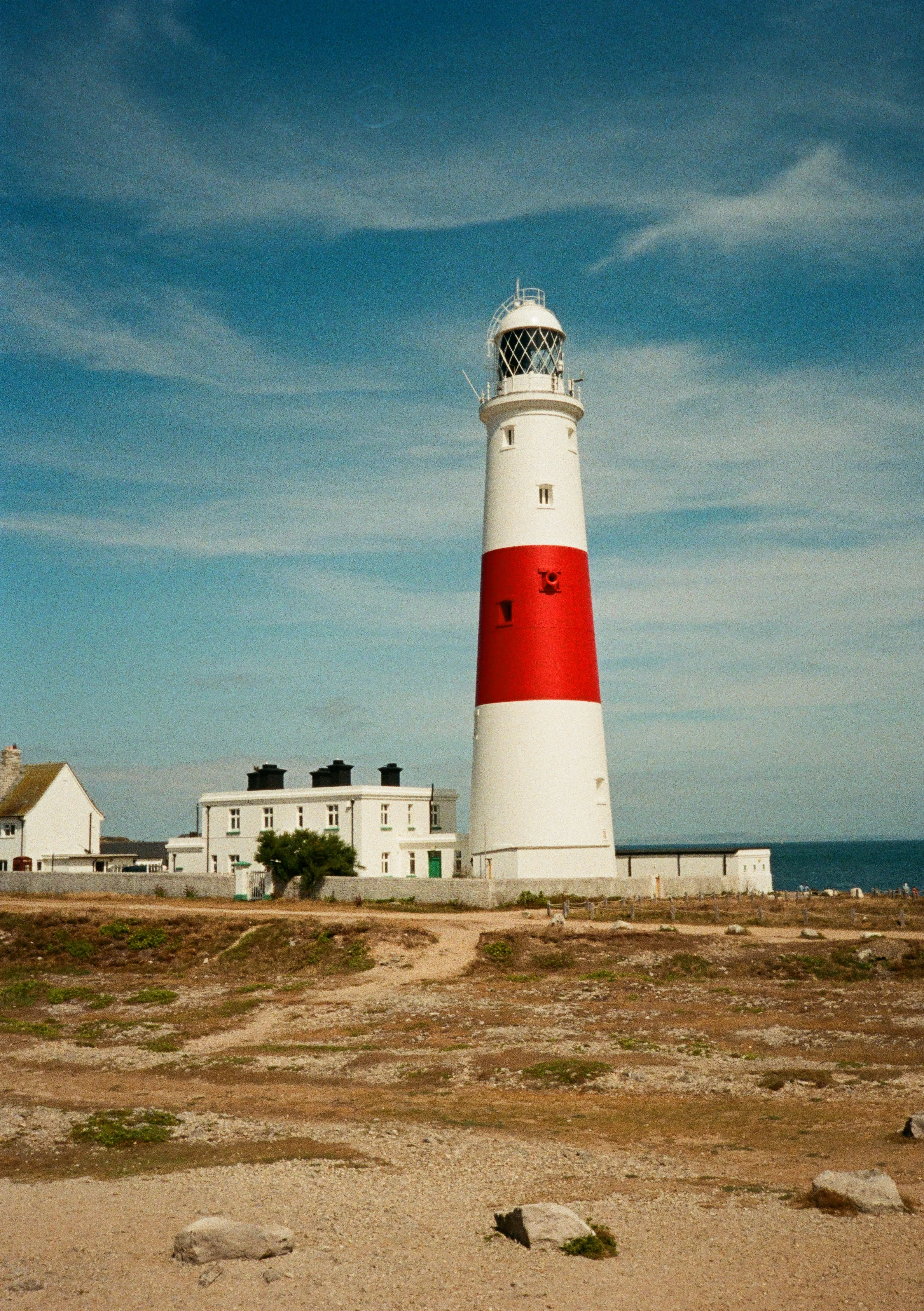 Iconic Red-Banded Lighthouse Against a Vivid Blue Sky