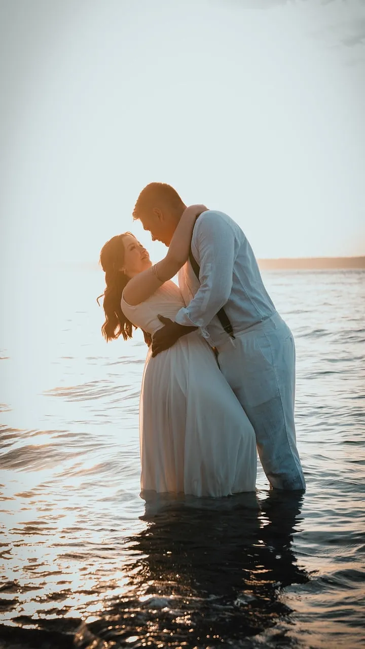 Romantic Sunset Kiss: Bride & Groom in Love at Sea