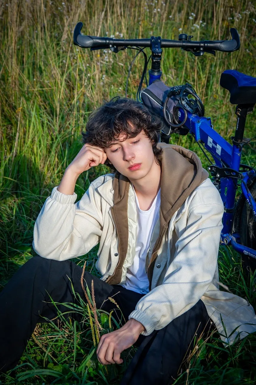 Serene Cyclist Rests Amidst Golden Hour Nature