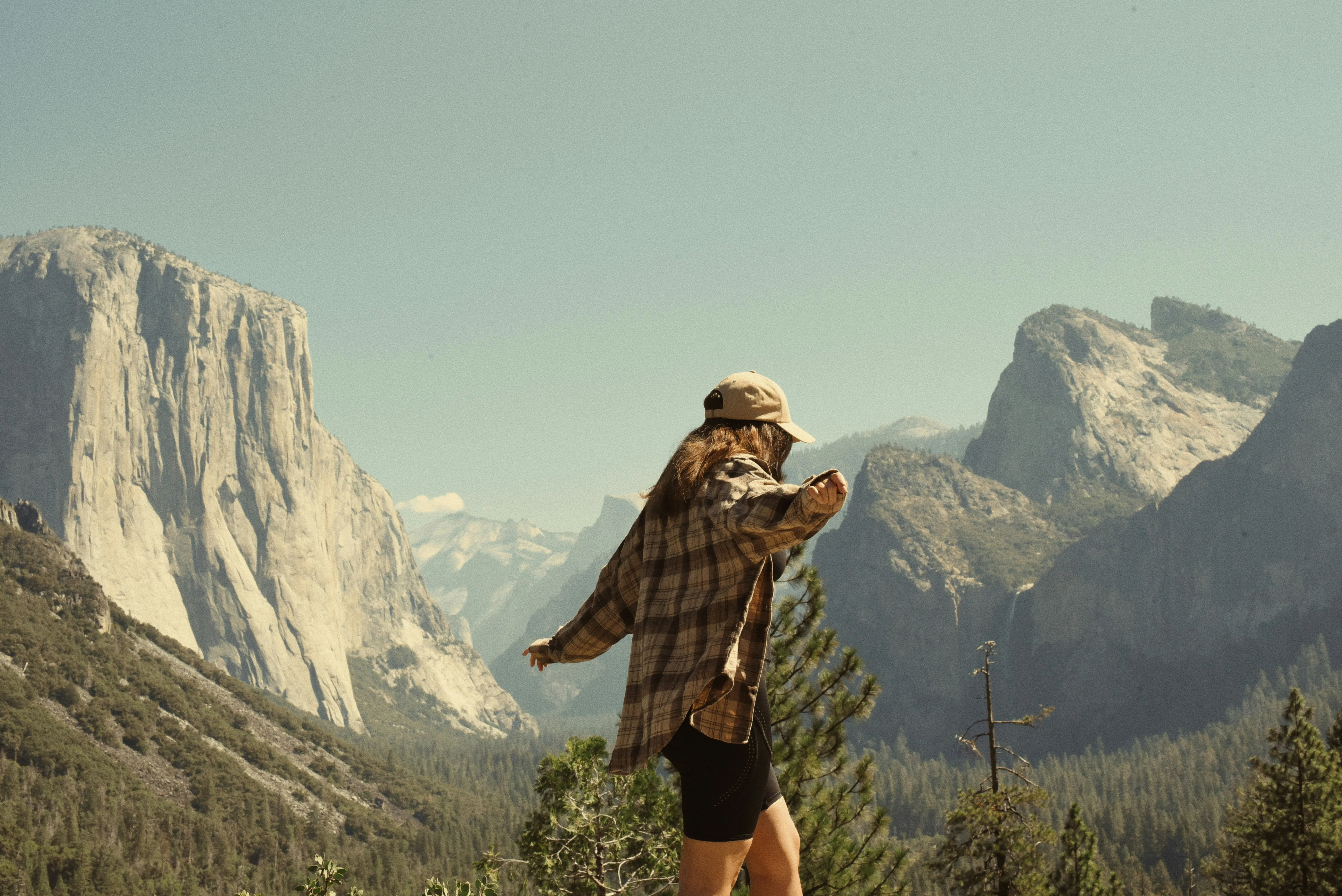 Breathtaking Yosemite: Woman Embodies Freedom Amidst Majestic Peaks