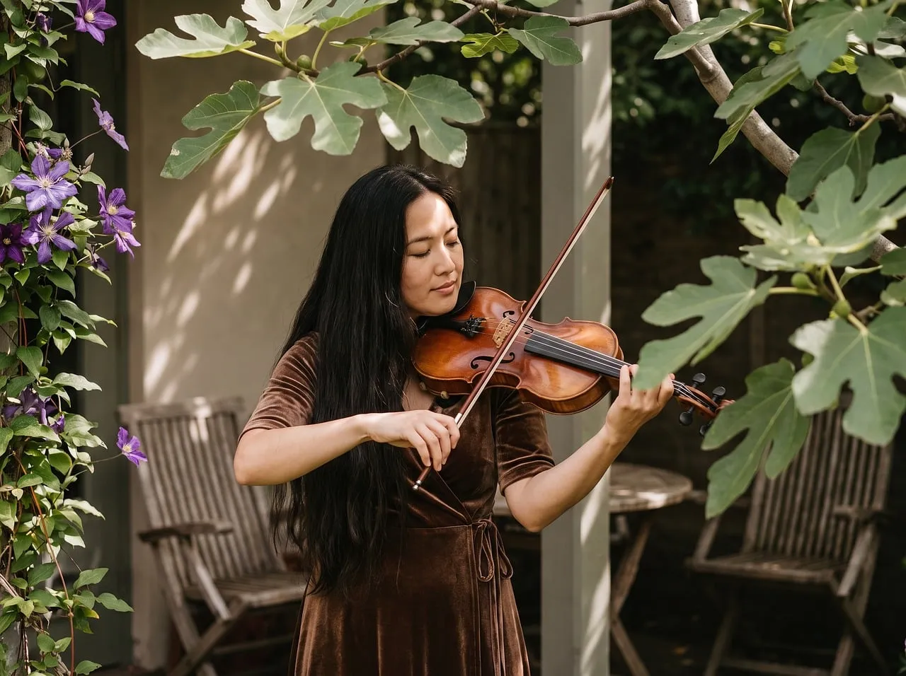 Serene Melodies: Woman Plays Violin Amidst Lush Greenery