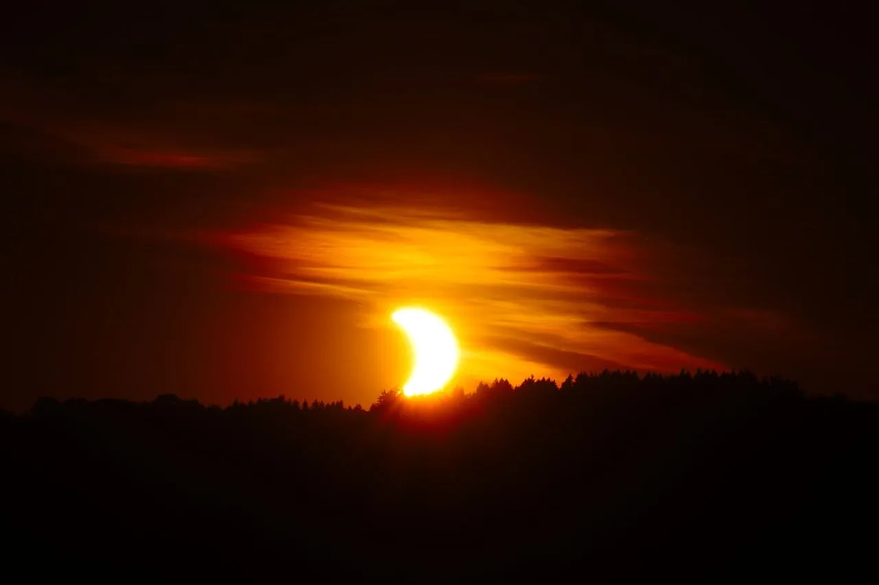 Breathtaking Solar Eclipse: Moon Veiling the Golden Sunset