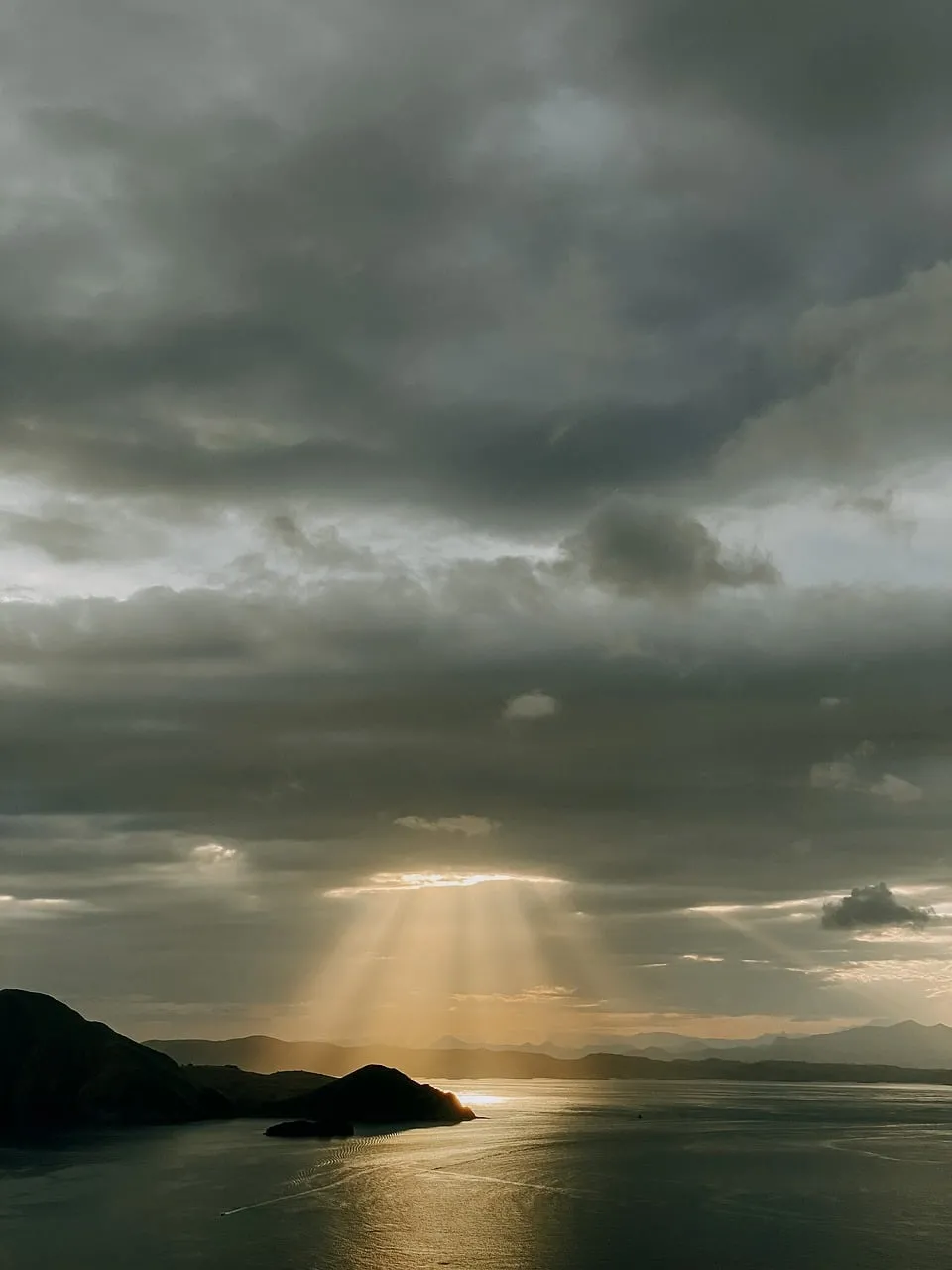 Dramatic Sun Rays Piercing Through Cloudy Sunset Sky