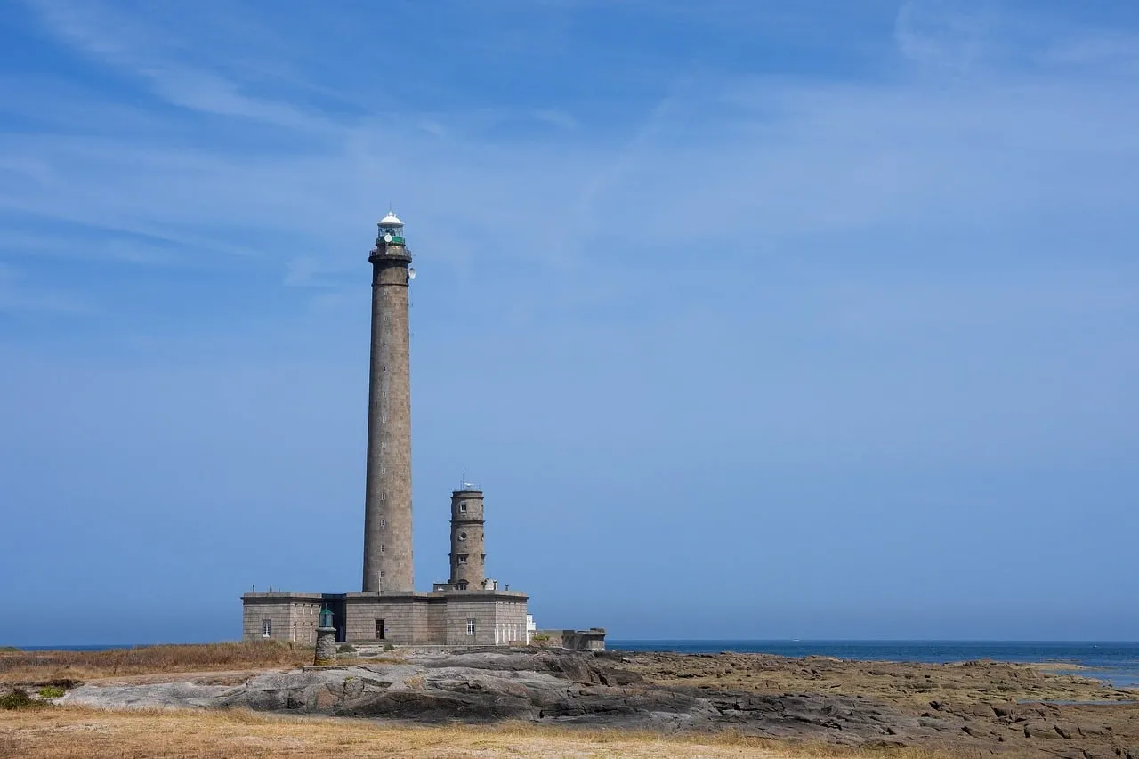Majestic Normandy Lighthouse: Coastal Grandeur Under Azure Skies