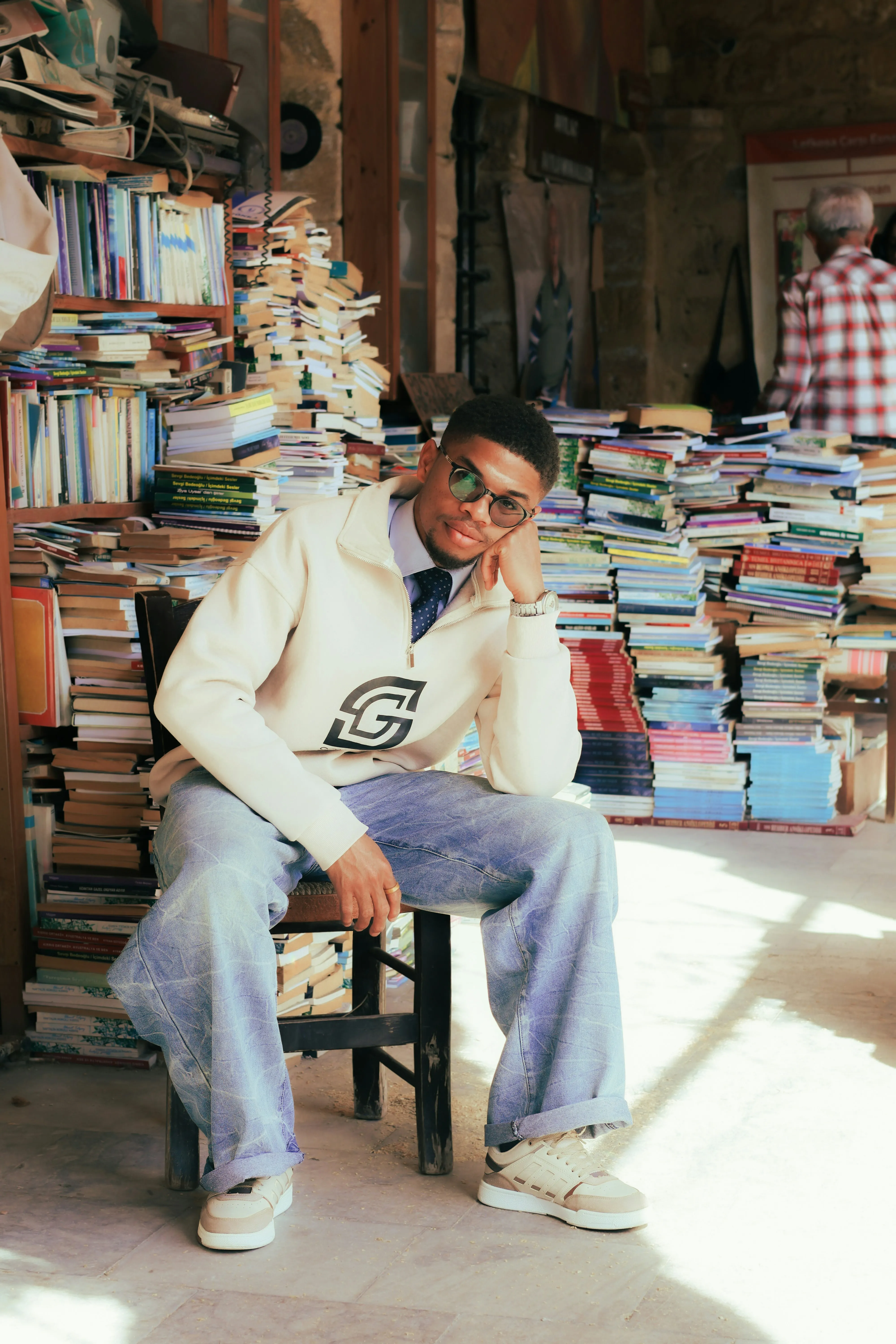 Stylish Young Man Lost in a Sea of Books