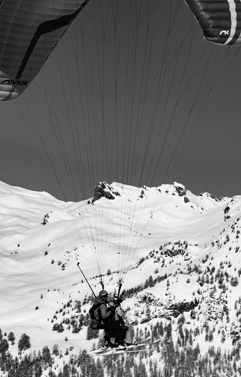 Adrenaline-Fueled Alpine Flight: Paragliding Over Snowy Peaks