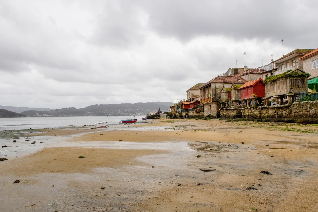 Charming Coastal Village: Timeless Beachfront Architecture Under Cloudy Skies
