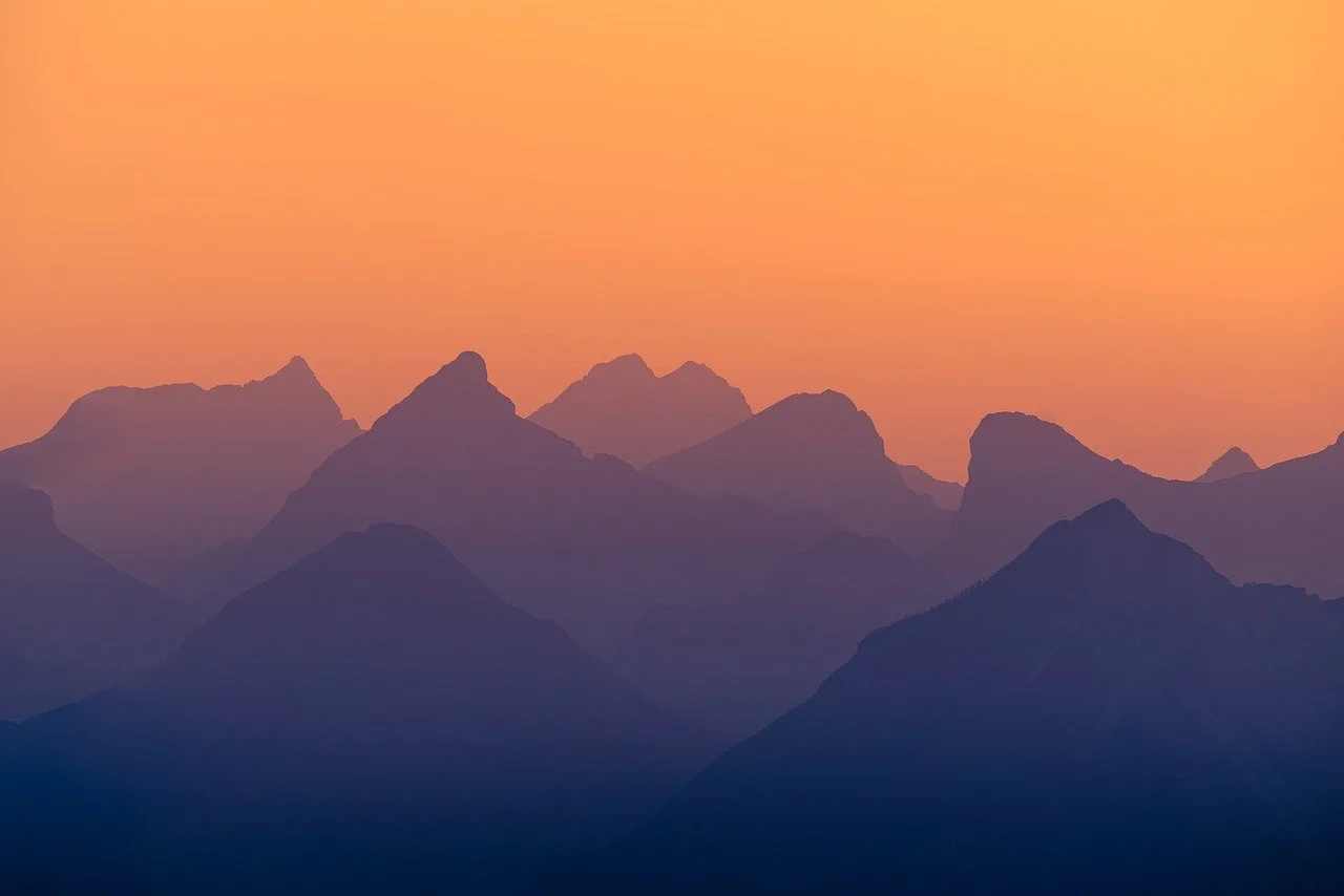 Breathtaking Mountain Alpenglow: Serene Sunset Silhouette
