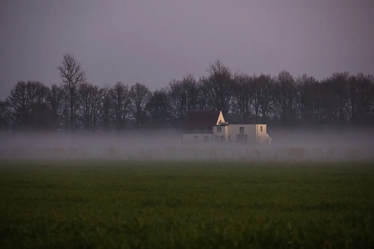 Mystical Twilight: Secluded Farmhouse in Autumnal Fog
