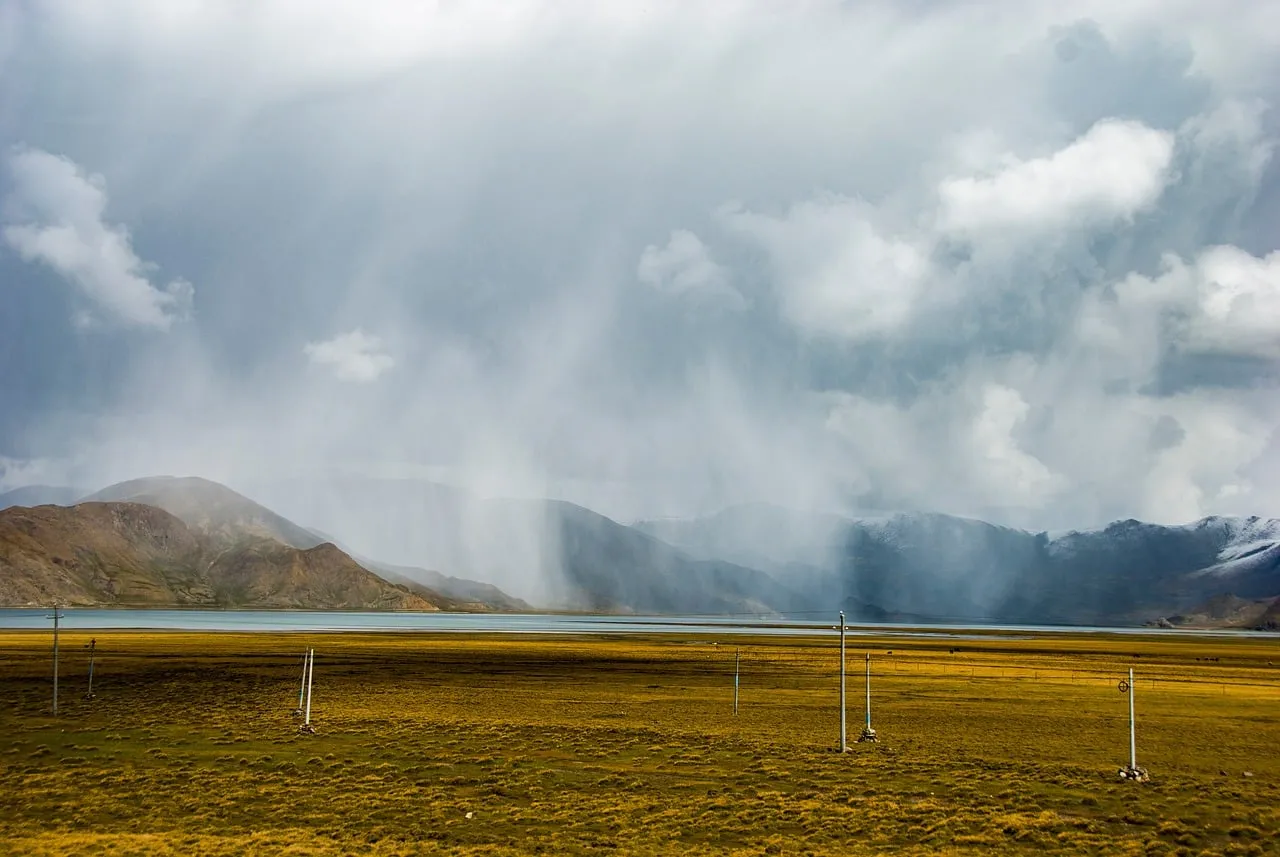 Dramatic Tibetan Plateau Storm: Rain Curtain Over Alpine Lake