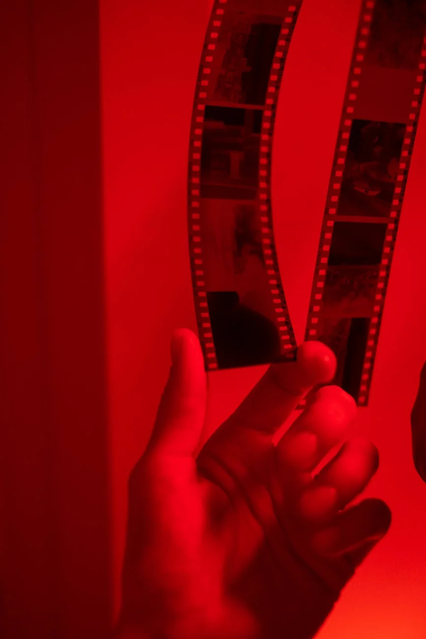 Dramatic Red Light: Developing Film Strip in the Darkroom