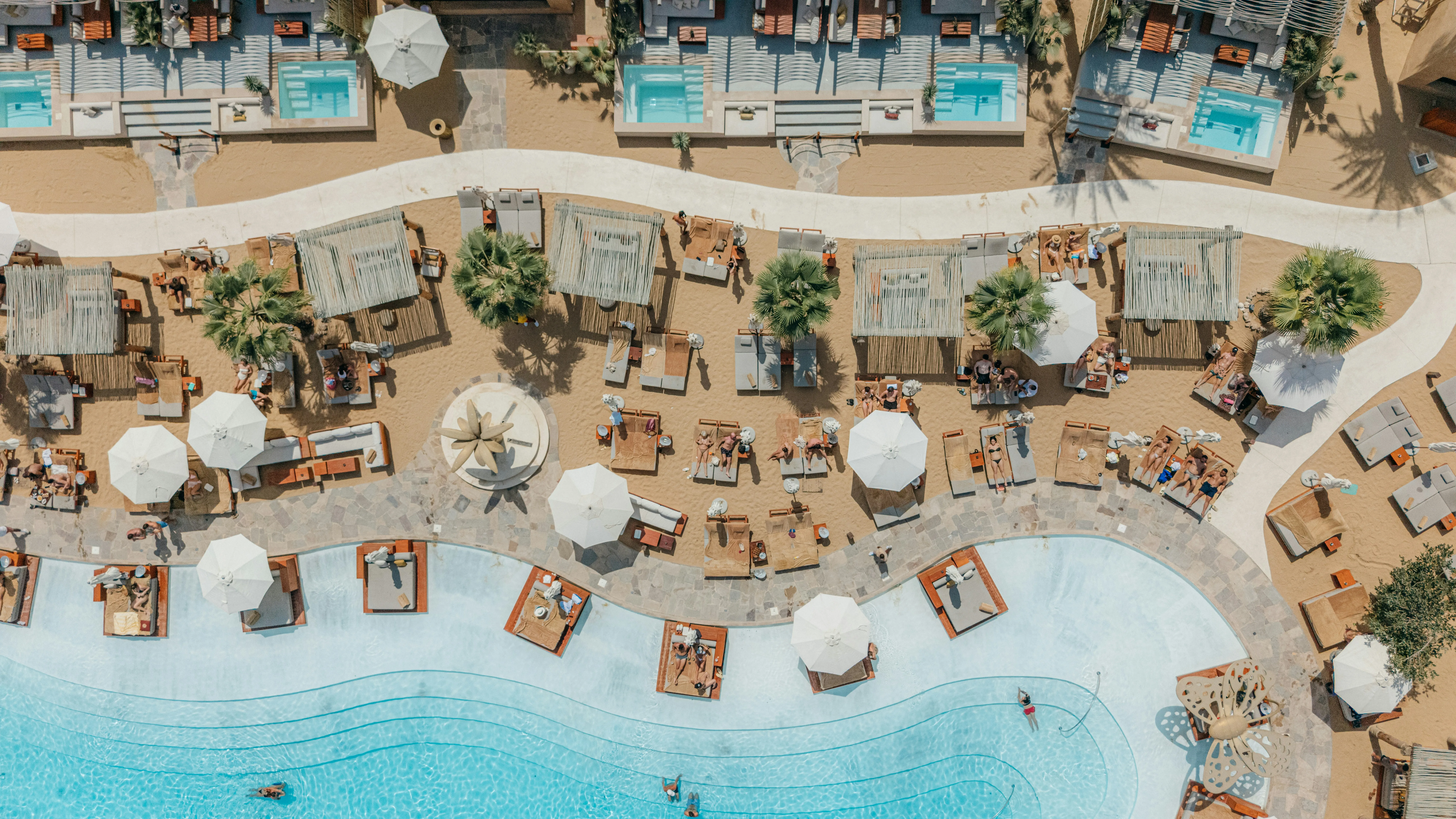 Stunning Aerial View: Luxurious Beach Resort Oasis with Sparkling Pools