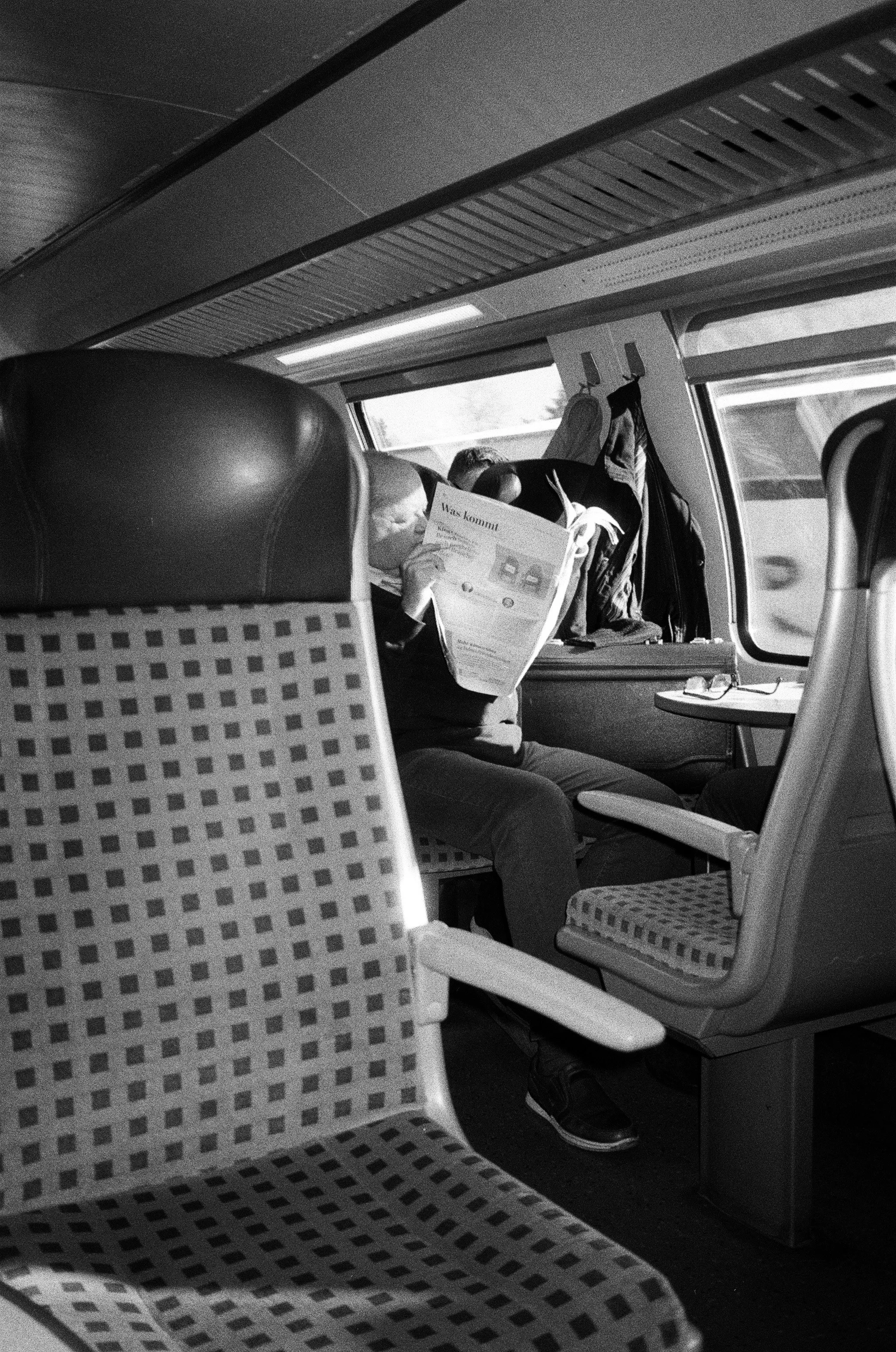 Timeless Journey: Man Lost in News on a Moving Train