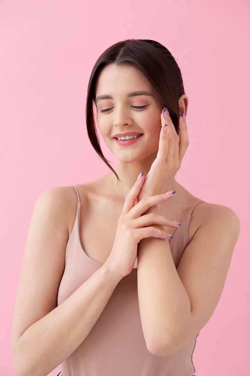Radiant Serenity: Woman's Peaceful Smile on Pink Background