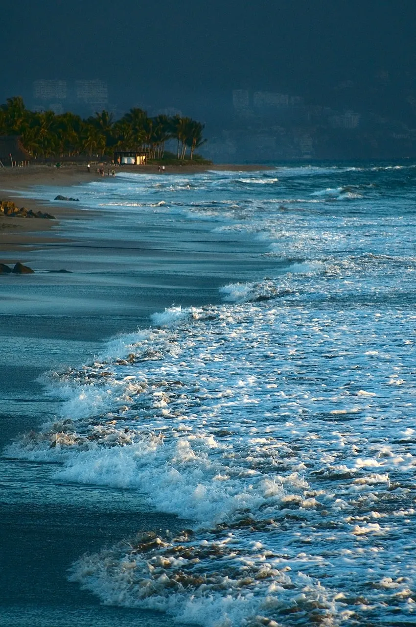 Dramatic Sunset Beach: Waves Crash on a Serene Coast