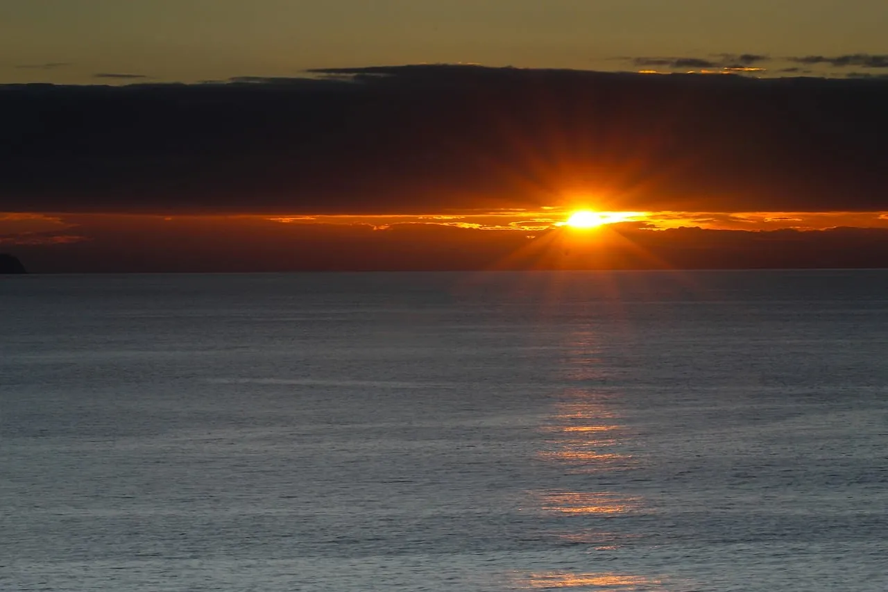 Breathtaking Ocean Sunset: Golden Rays Over Calm Seas