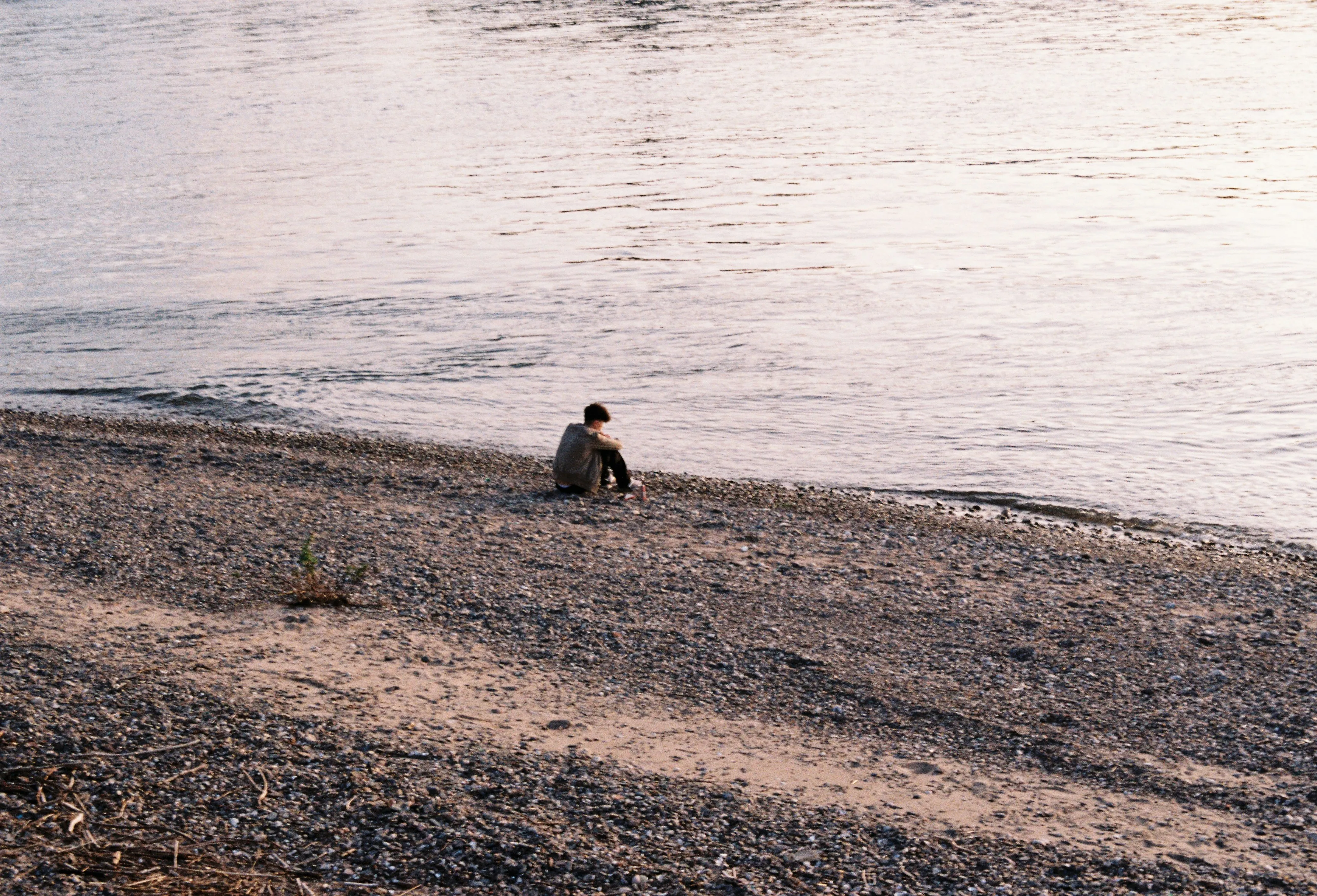 Solitude by the Shore: Reflective Moments on a Rocky Beach