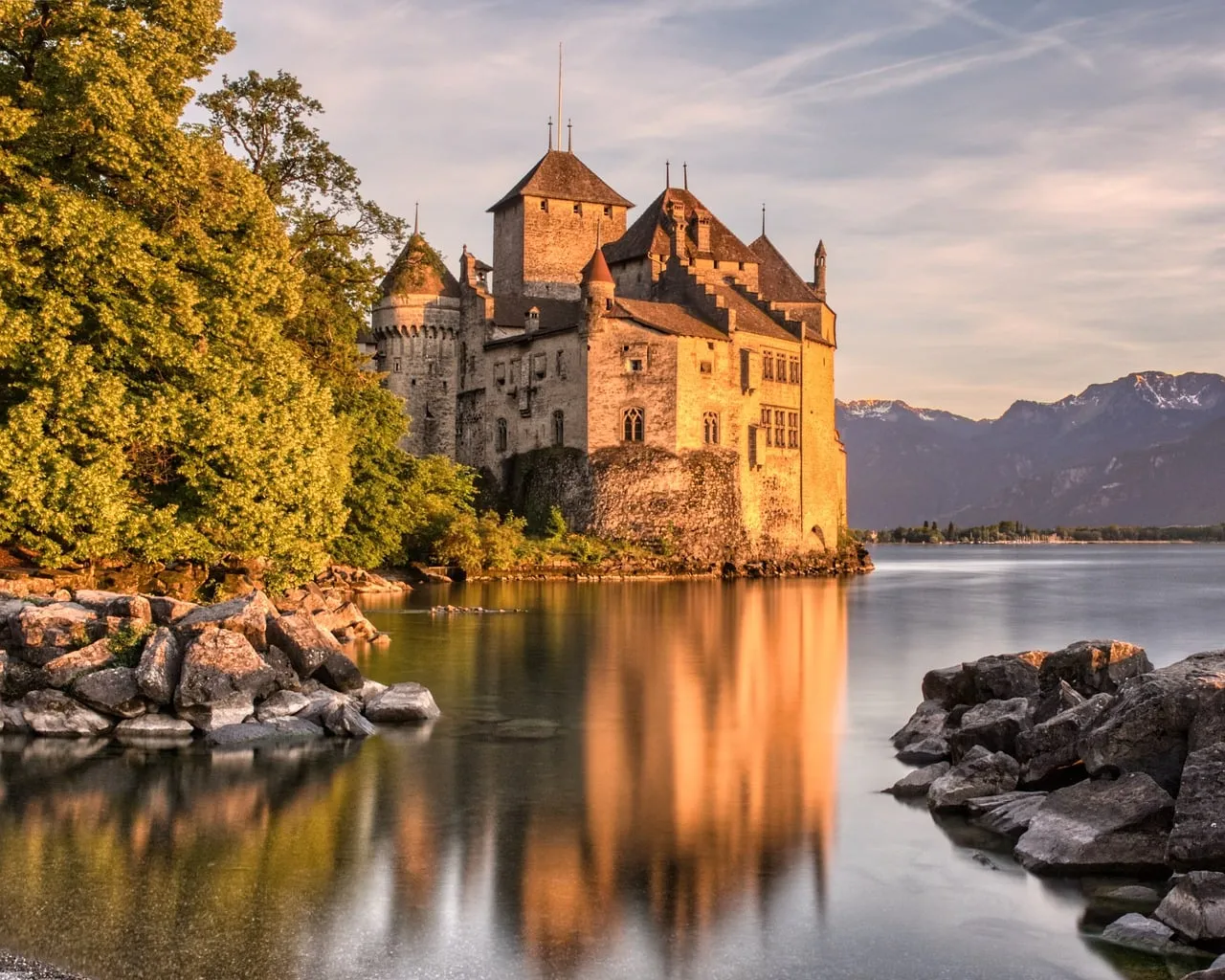 Enchanting Chillon Castle Sunset: Alpine Reflection on Lake Geneva