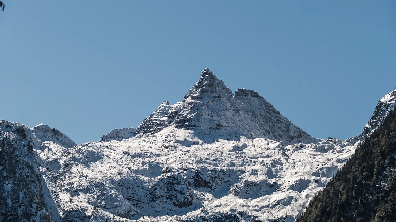 Breathtaking Alps: Majestic Snowy Peak Under Clear Sky