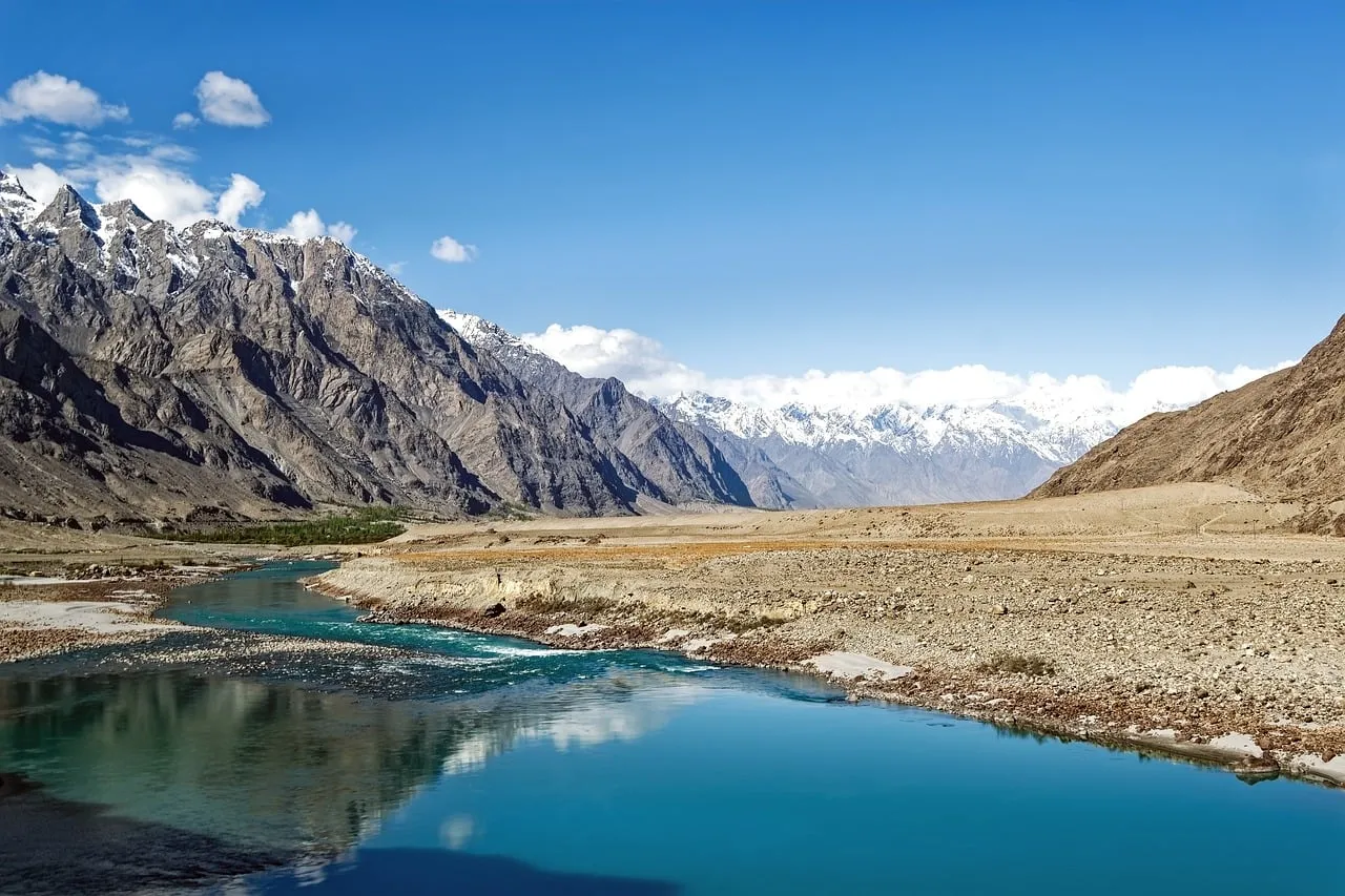 Breathtaking Karakoram: Turquoise River Meanders Through Majestic Peaks