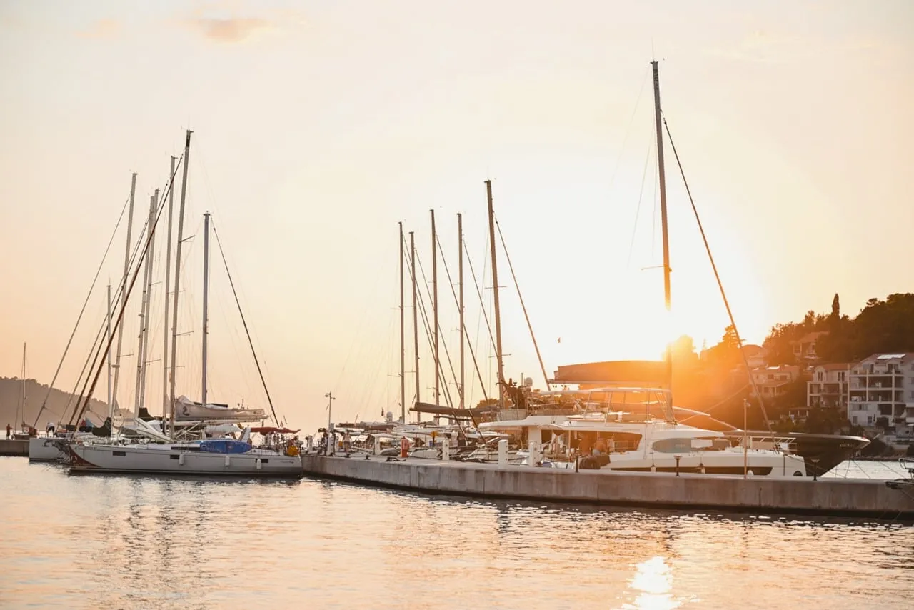 Golden Harbor Sunset: Yachts Bathed in Evening Glow