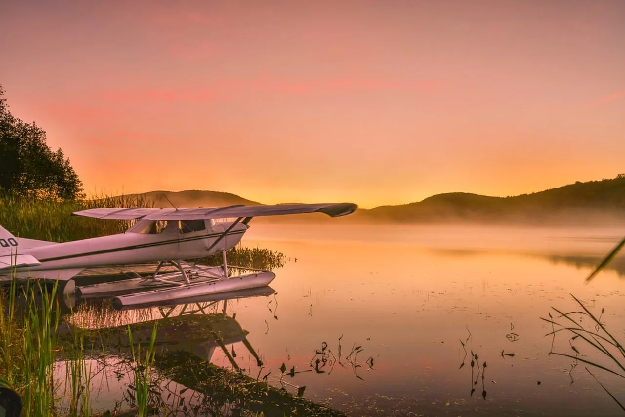 Breathtaking Autumn Dawn: Seaplane on a Tranquil Québec Lake