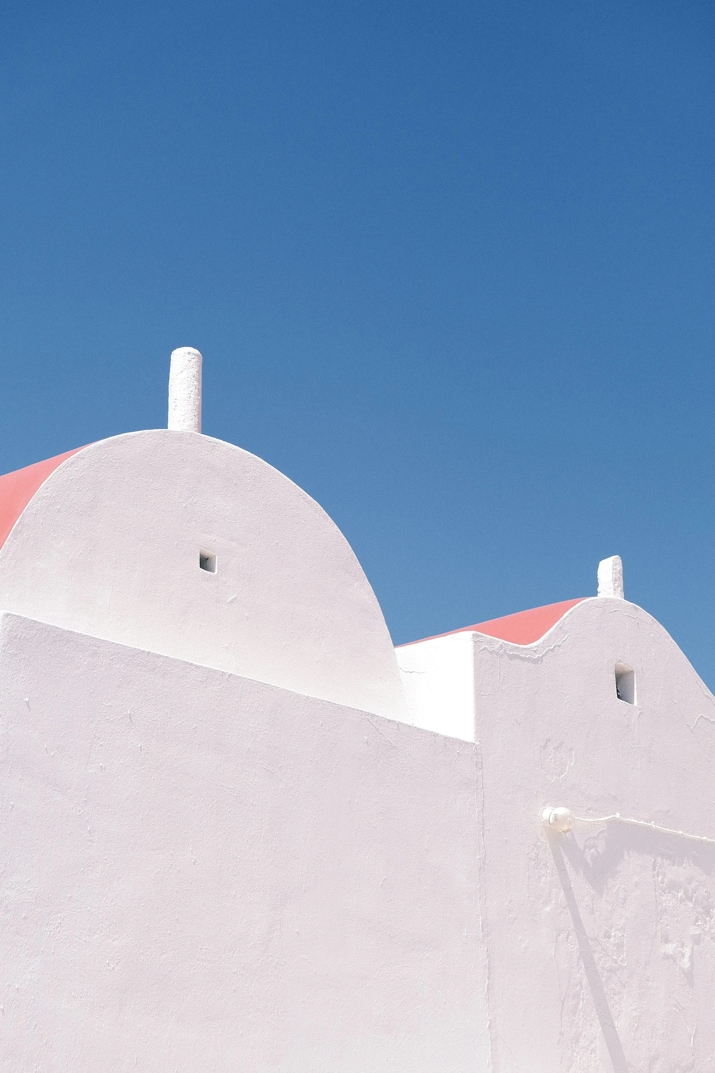Minimalist Aegean Charm: White Architecture Under Azure Skies
