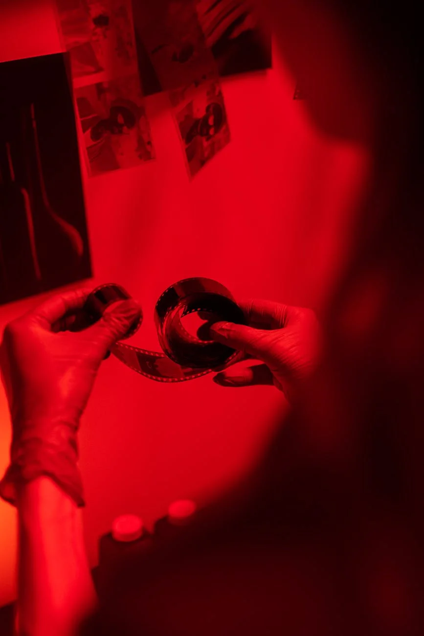 Enigmatic Red: Hands Developing Film in a Darkroom