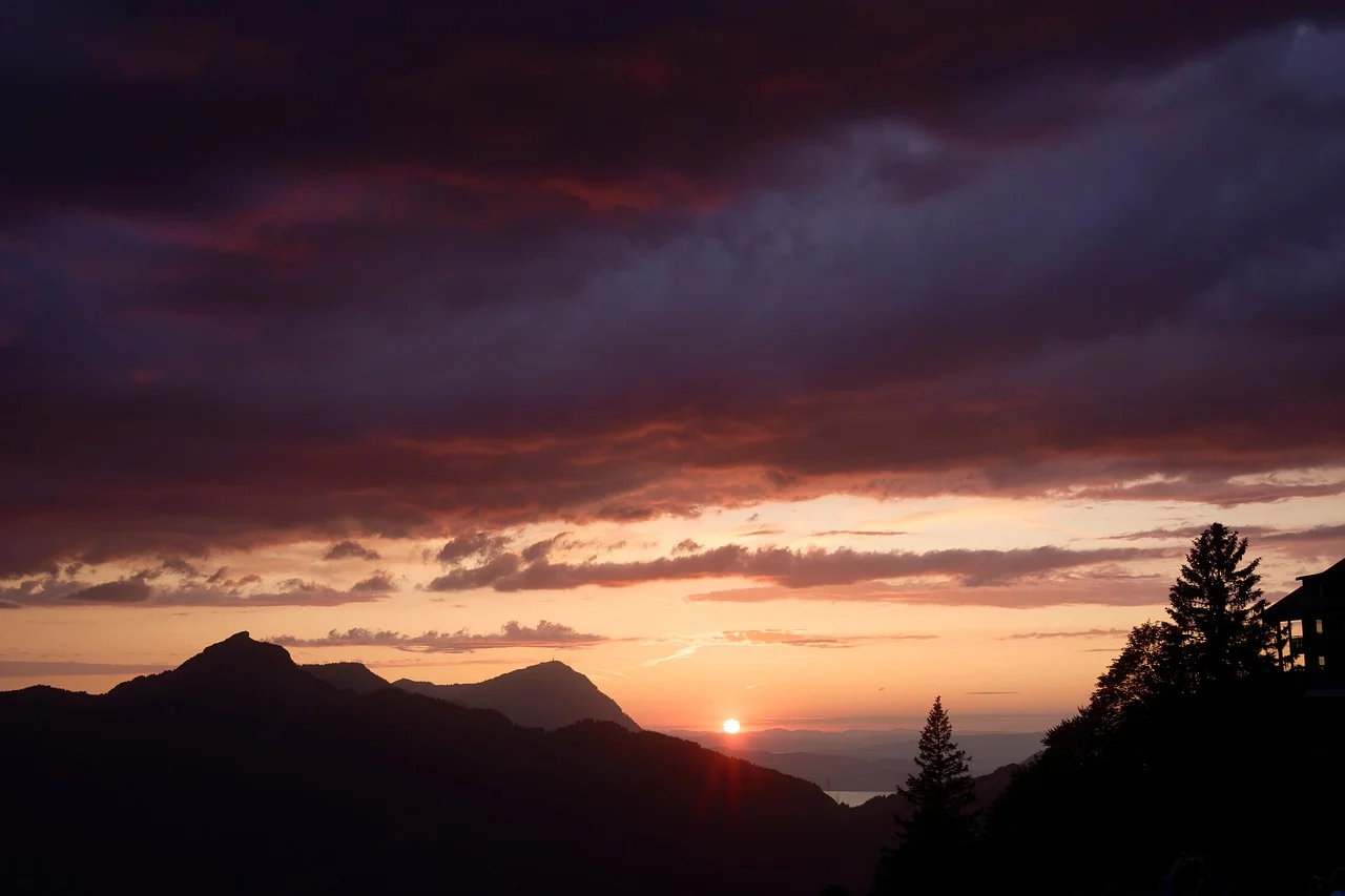 Dramatic Alpine Sunset: Fiery Skyscape Over Stoos Mountains